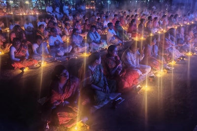 A large group of people sitting on the ground