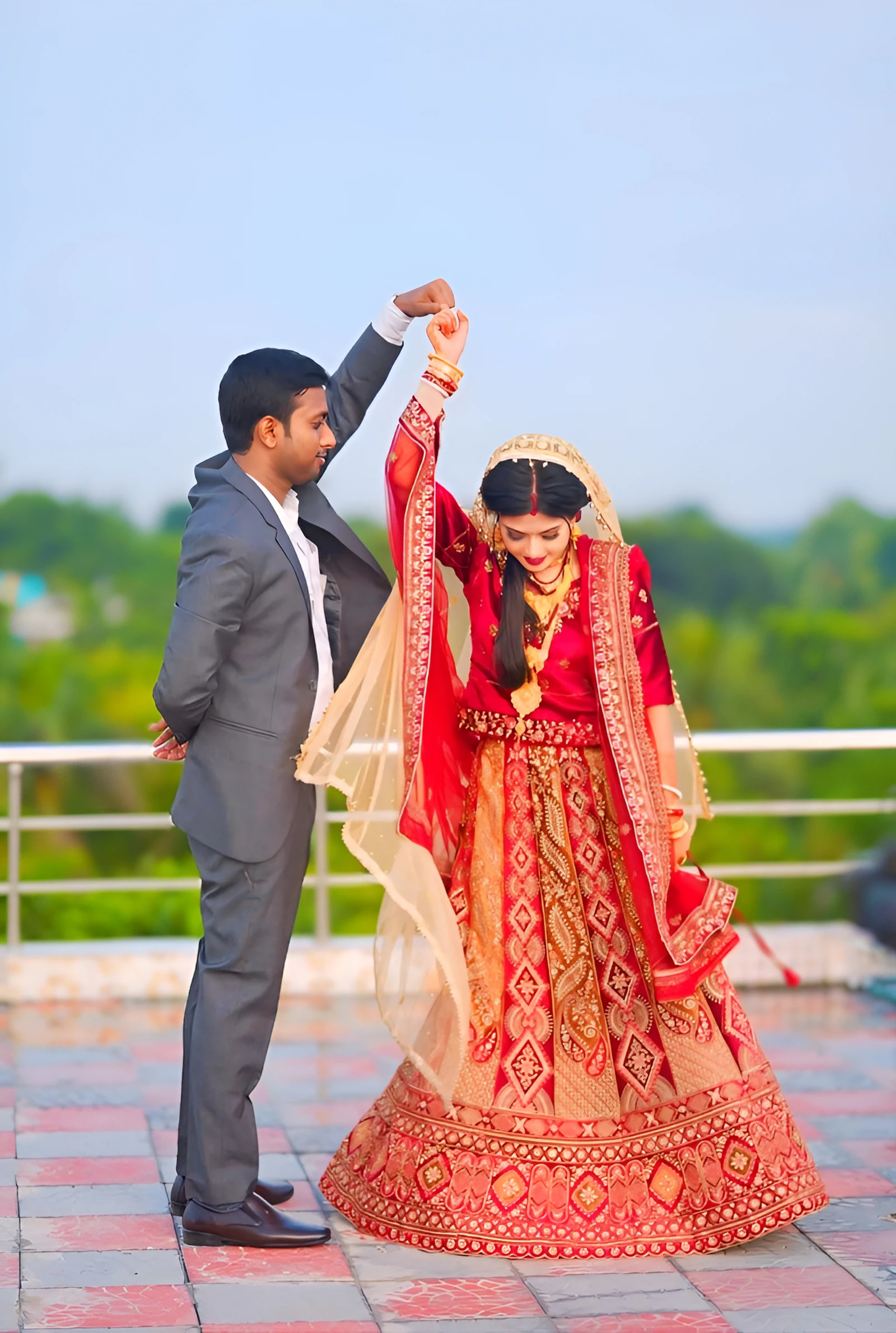 A bride and groom dancing together in a courtyard at night, filmed by Vedant