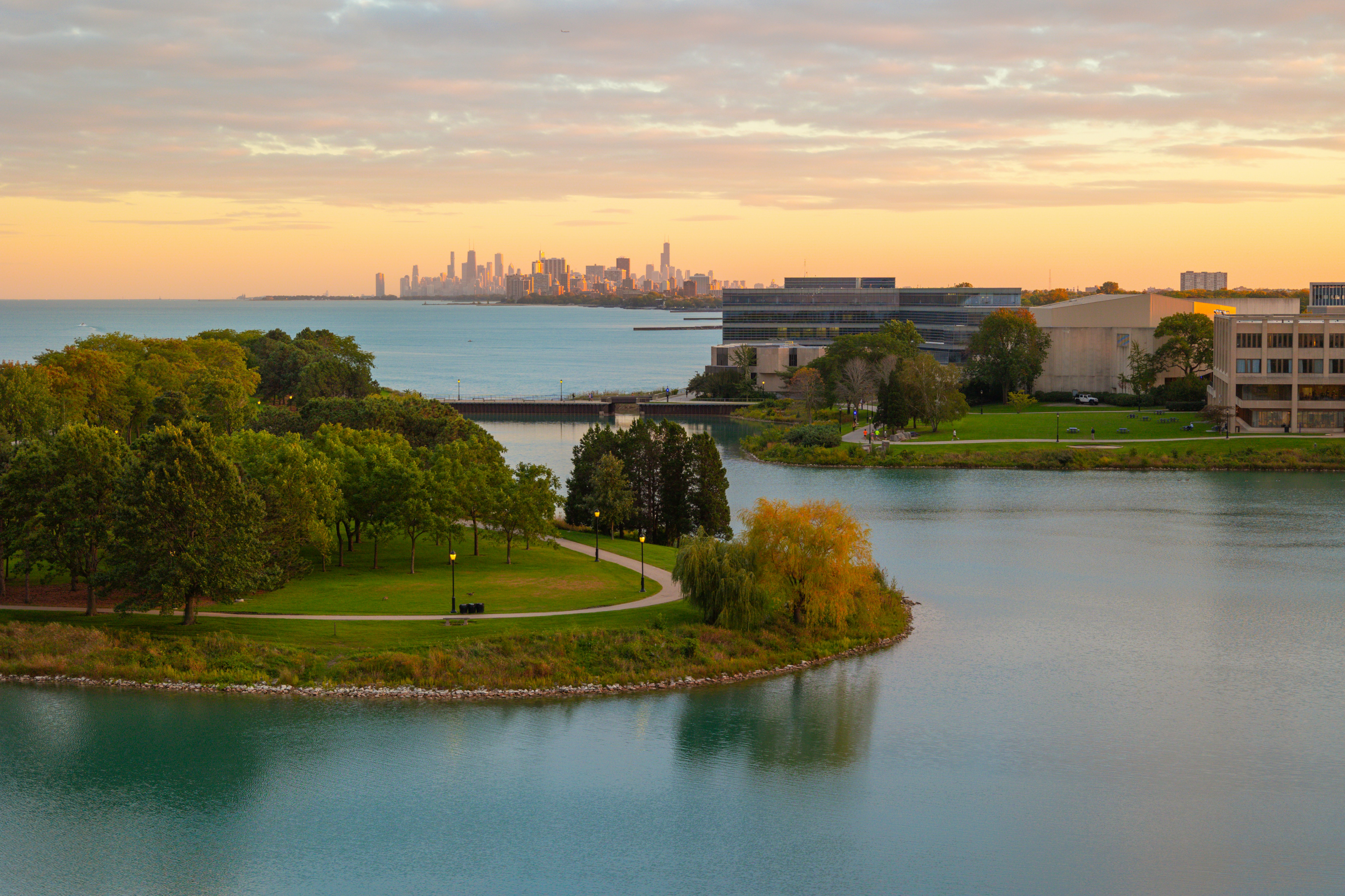 A body of water surrounded by trees and buildings