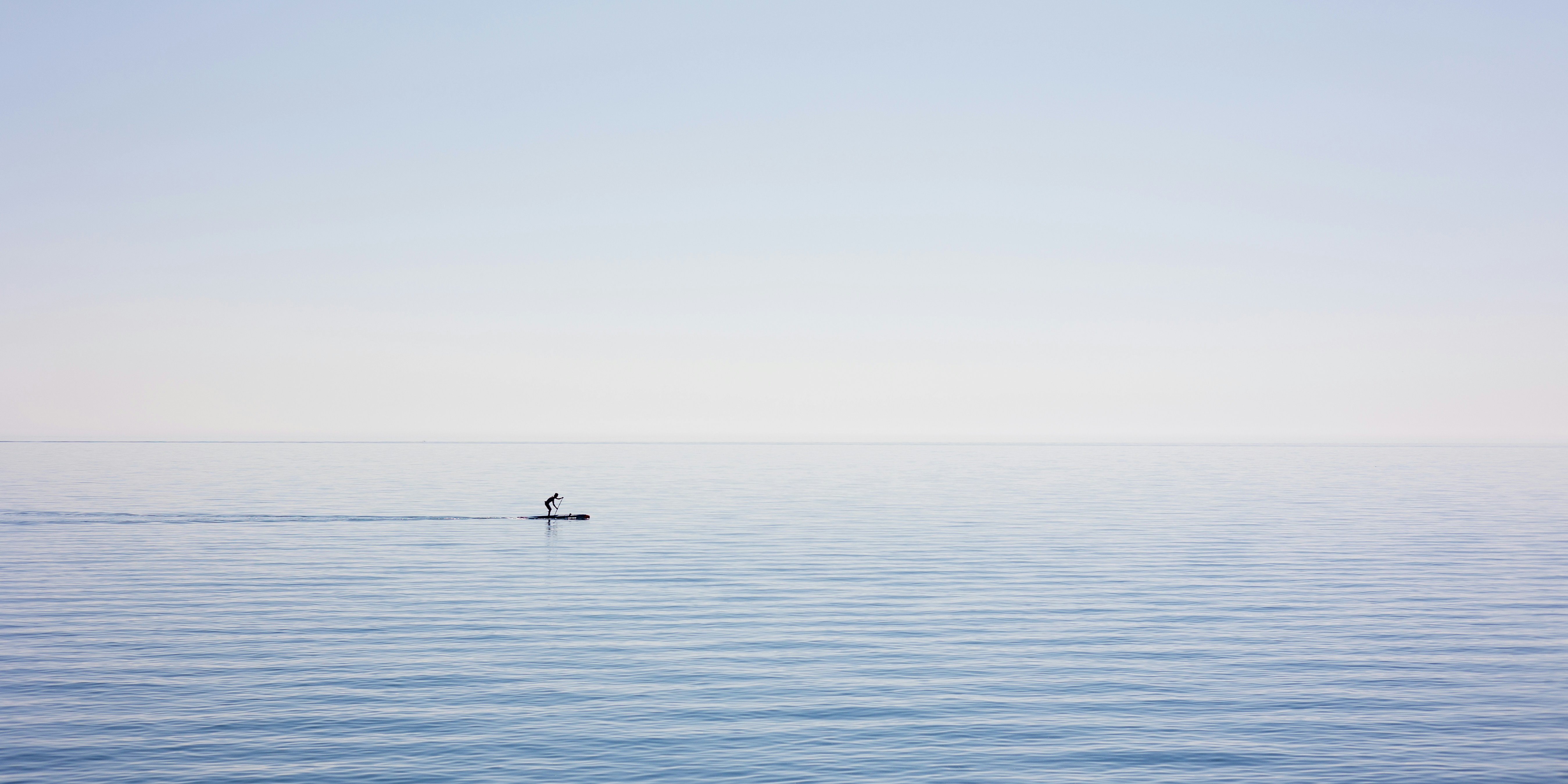 A lone boat floating in the middle of the ocean