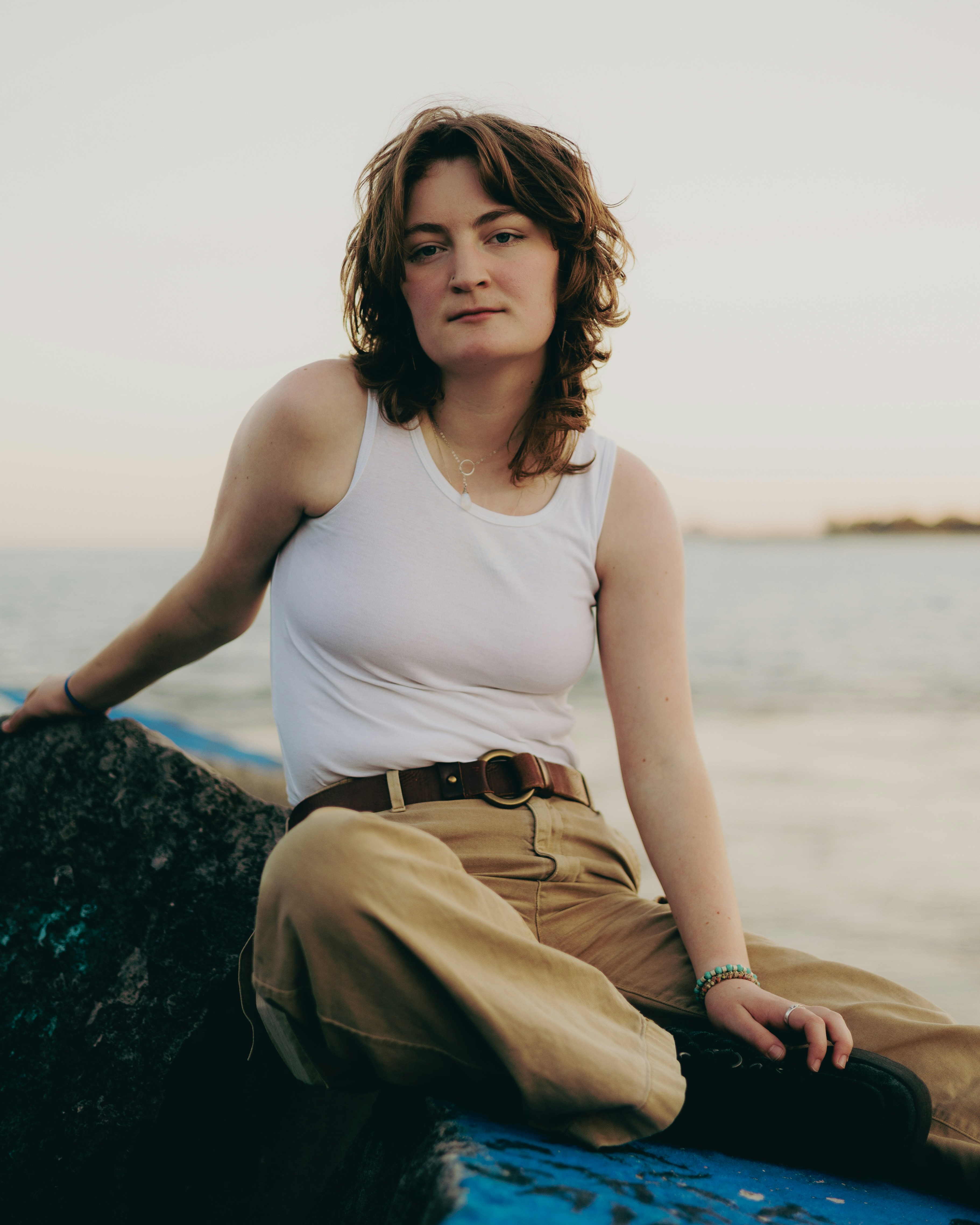 A woman is sitting on a boat in the water