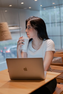 A woman sitting at a table with a laptop