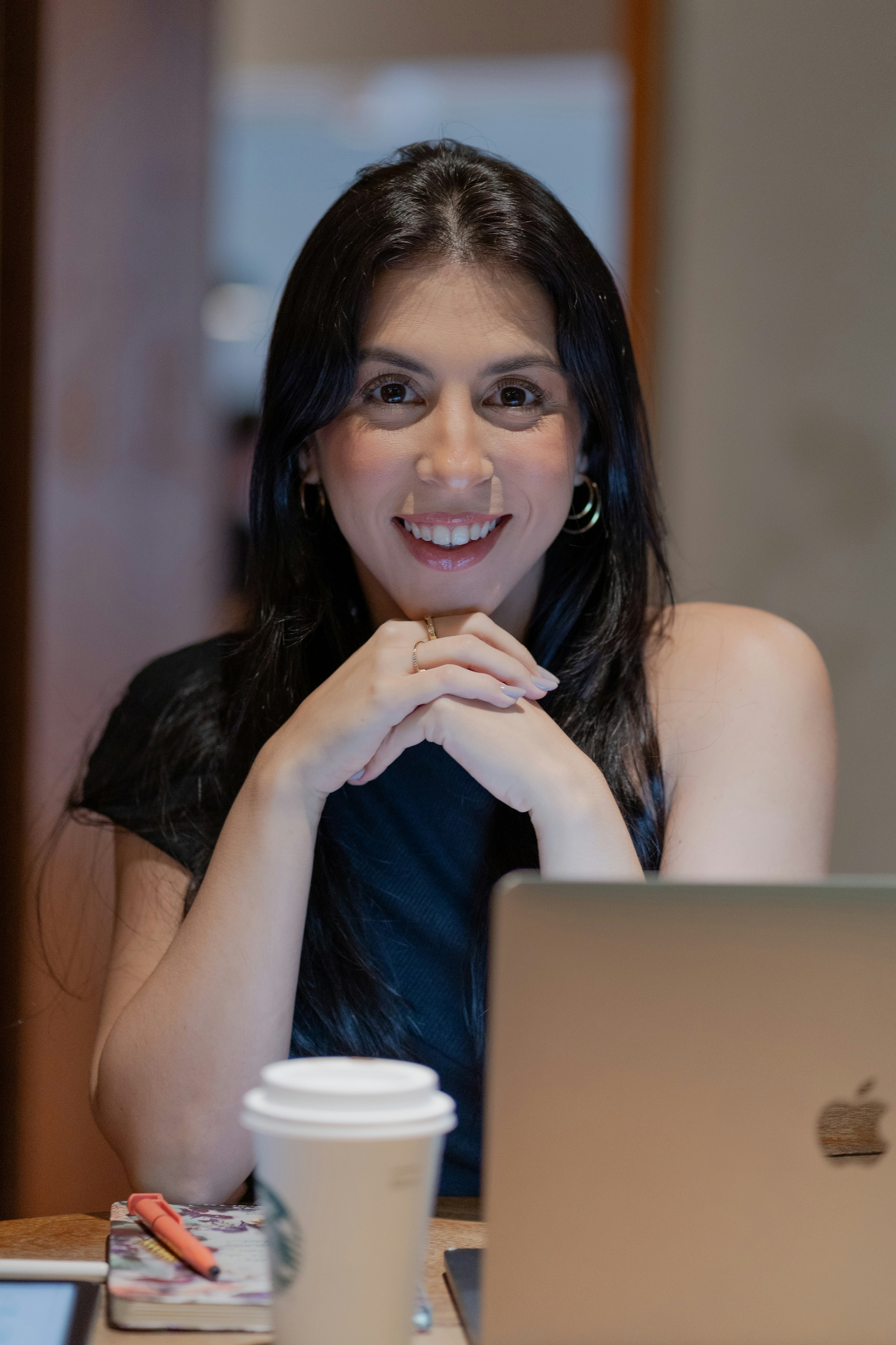 A woman sitting in front of a laptop computer