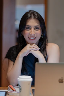 A woman sitting in front of a laptop computer