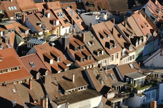 An aerial view of a city with many roofs