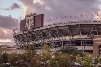 A stadium with a cloudy sky in the background