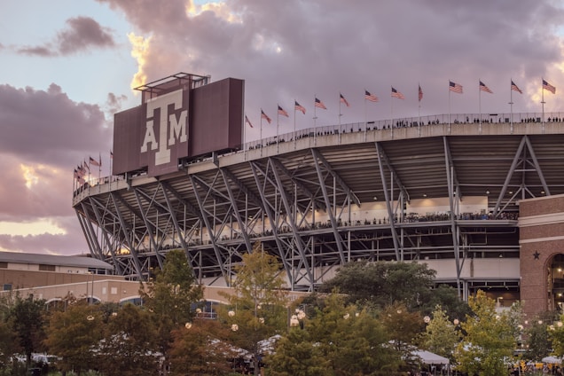 A stadium with a cloudy sky in the background
