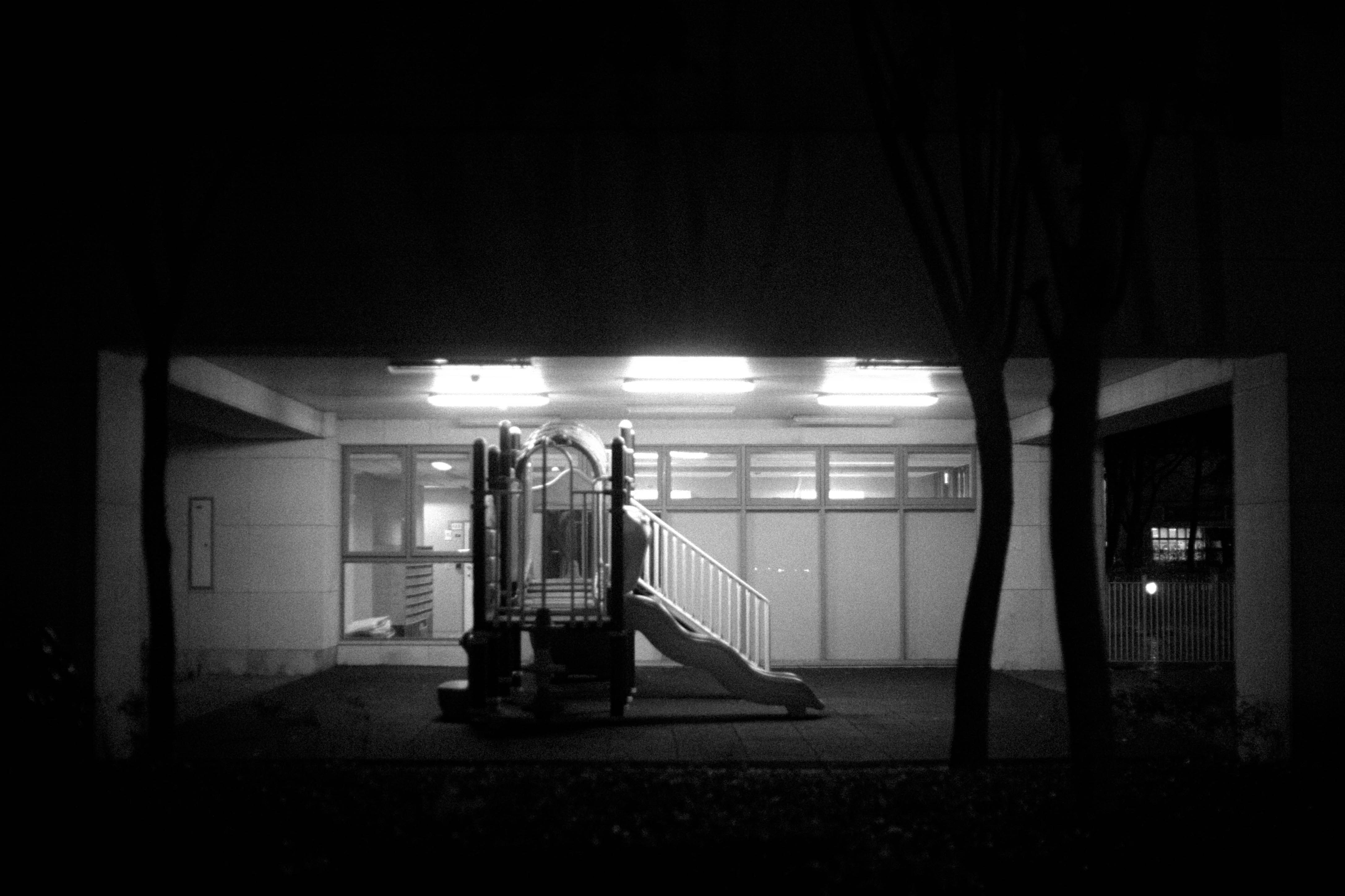 A black and white photo of a building at night