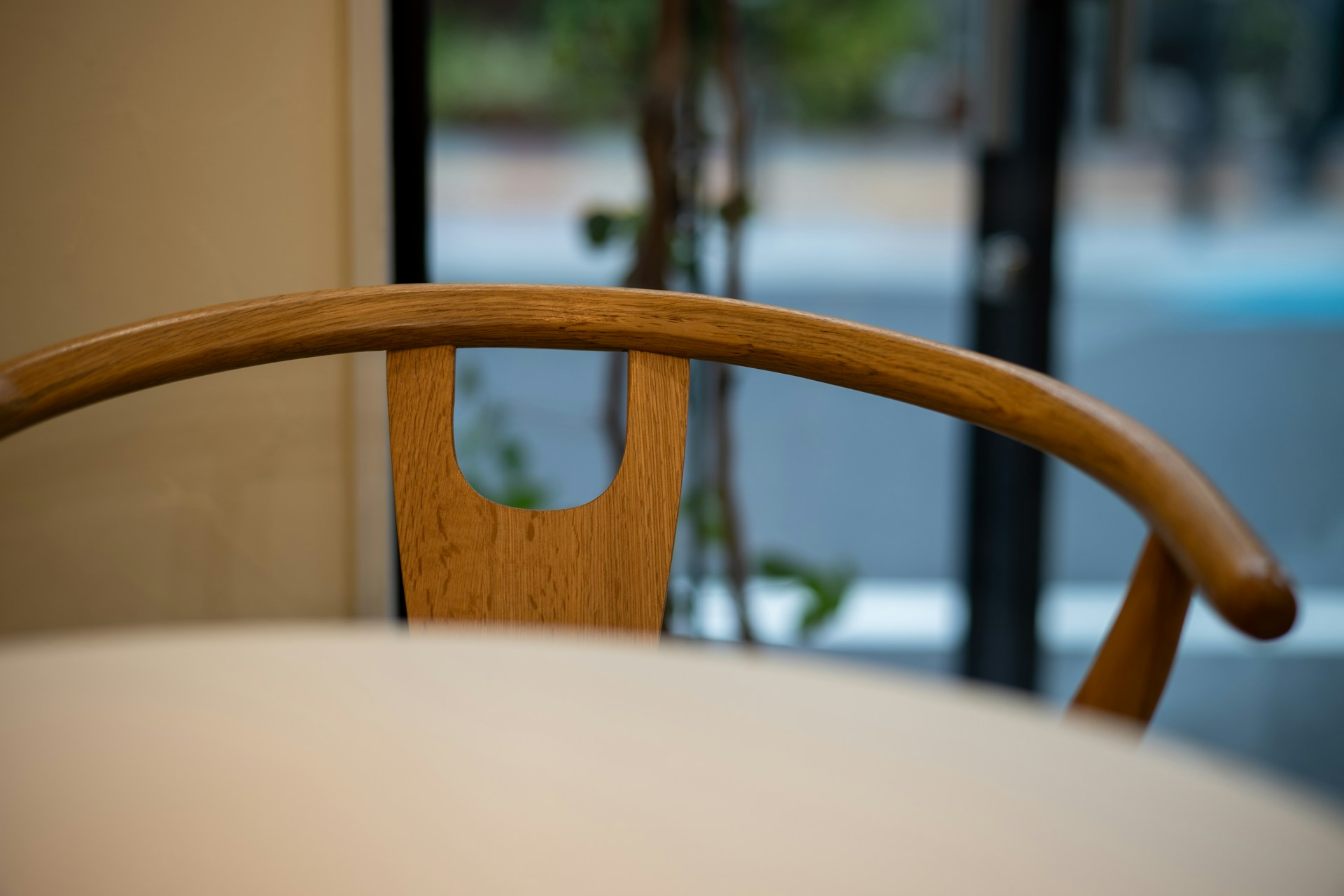 A wooden chair sitting in front of a window