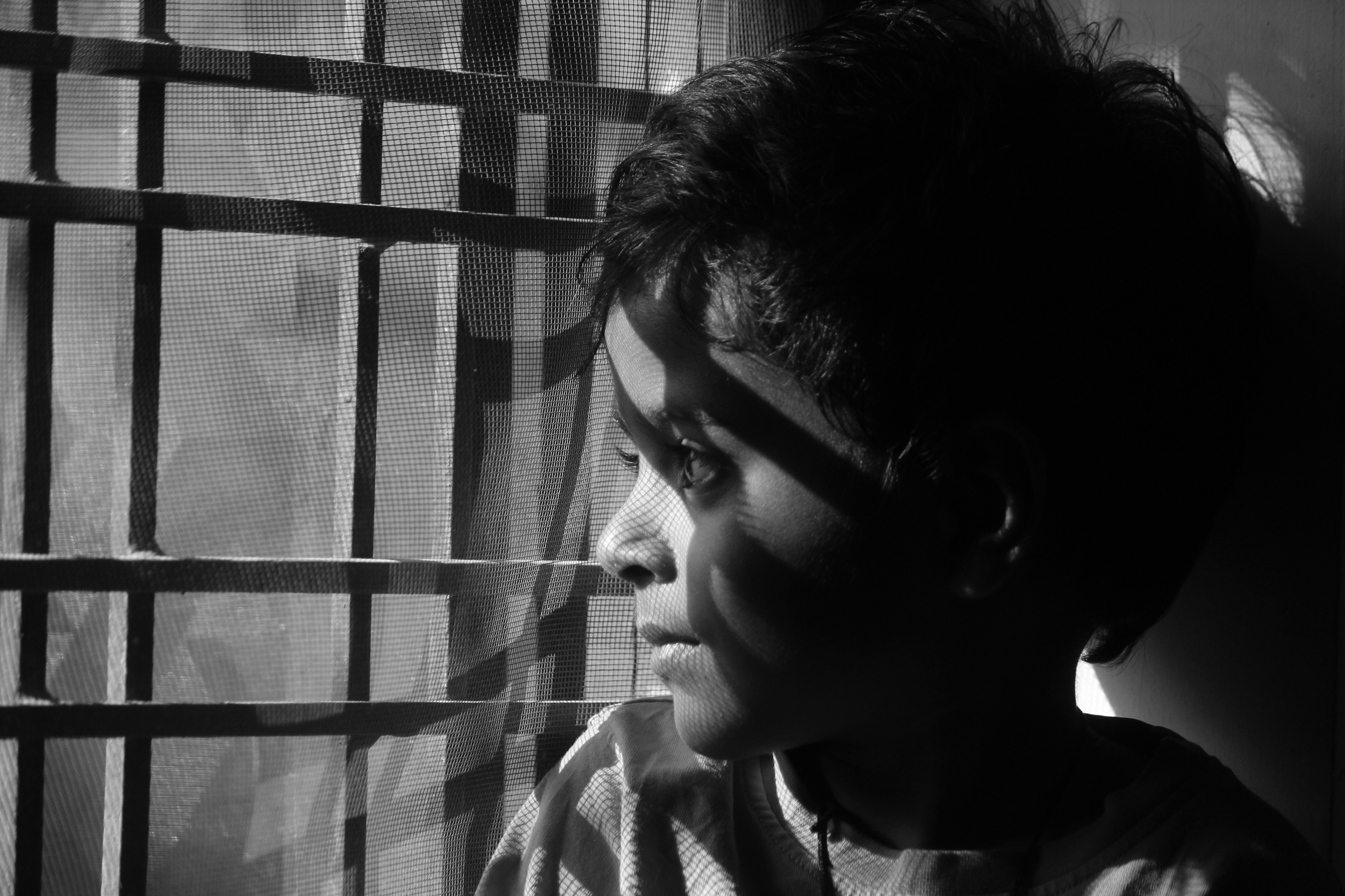 A woman standing in front of a window