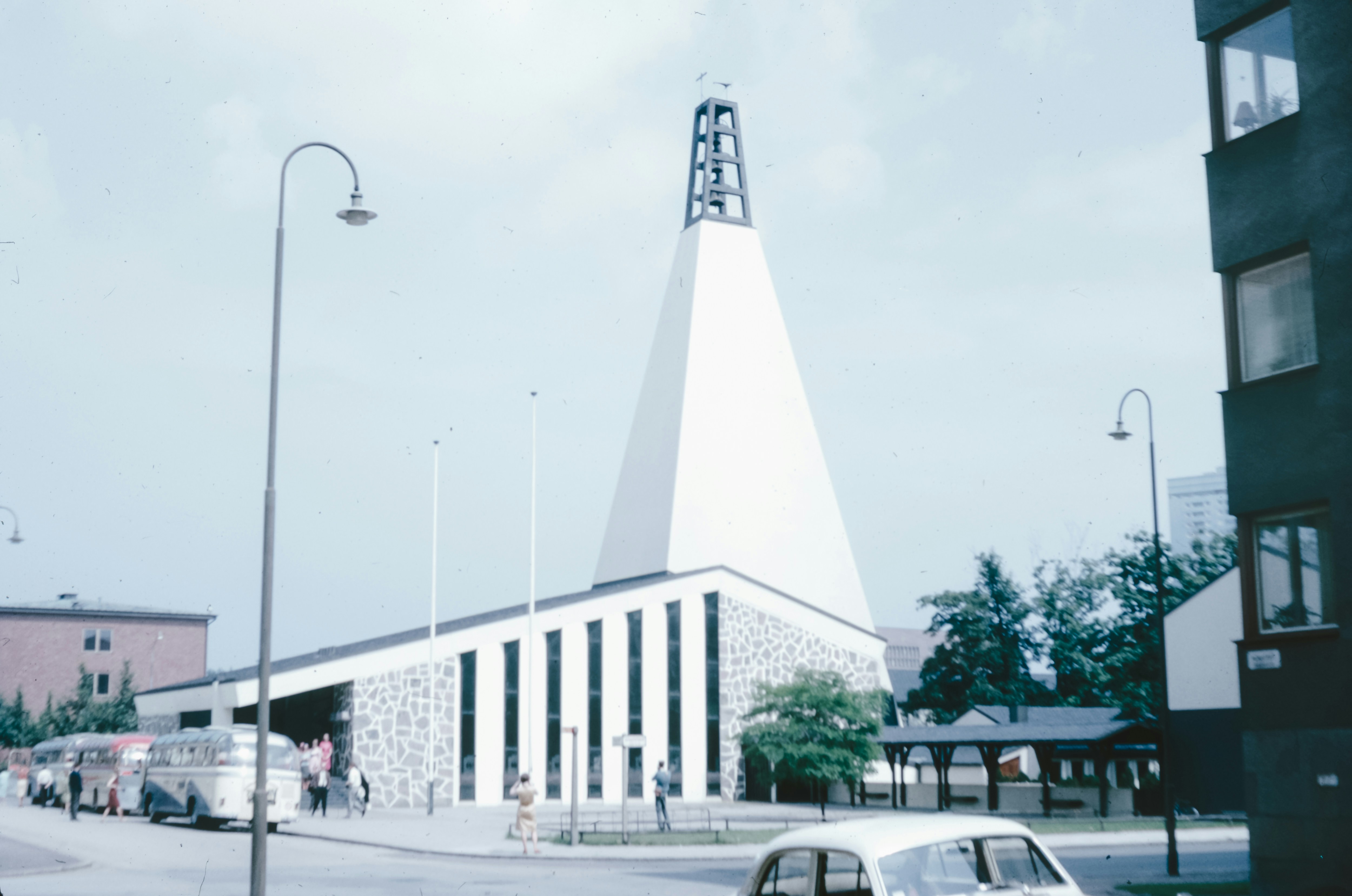 A car parked in front of a tall building