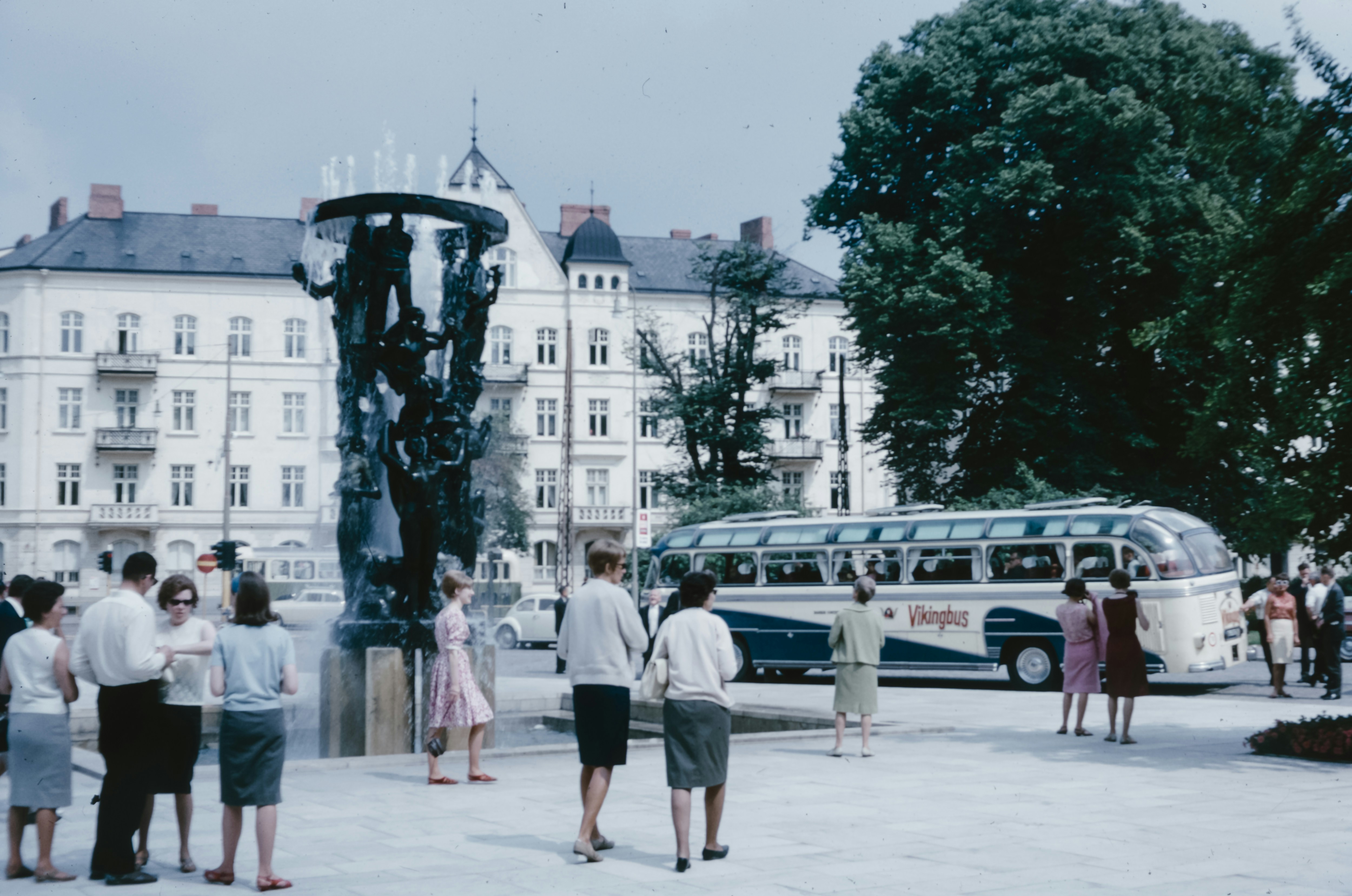 A group of people standing in front of a bus