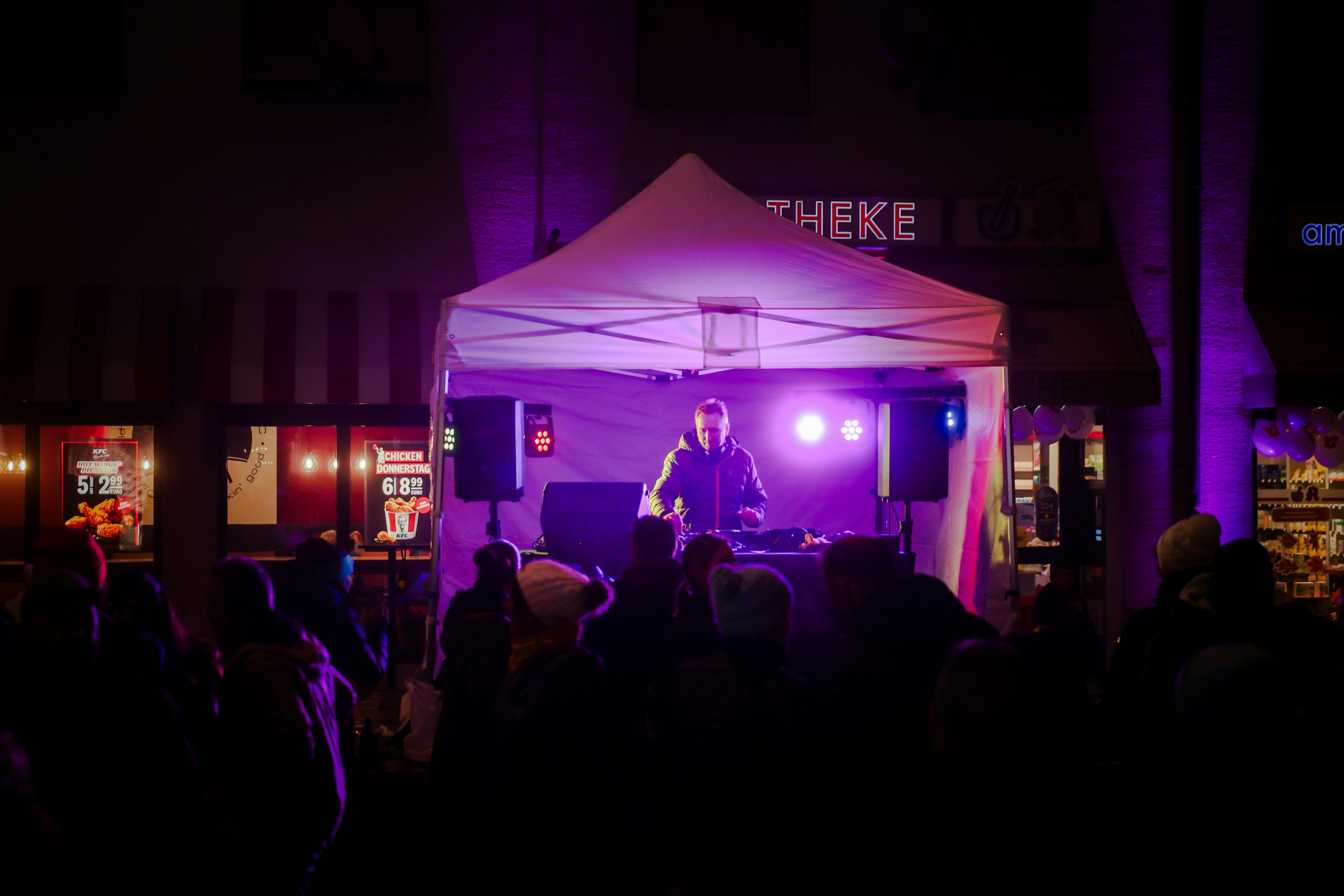 A group of people that are standing in front of a tent