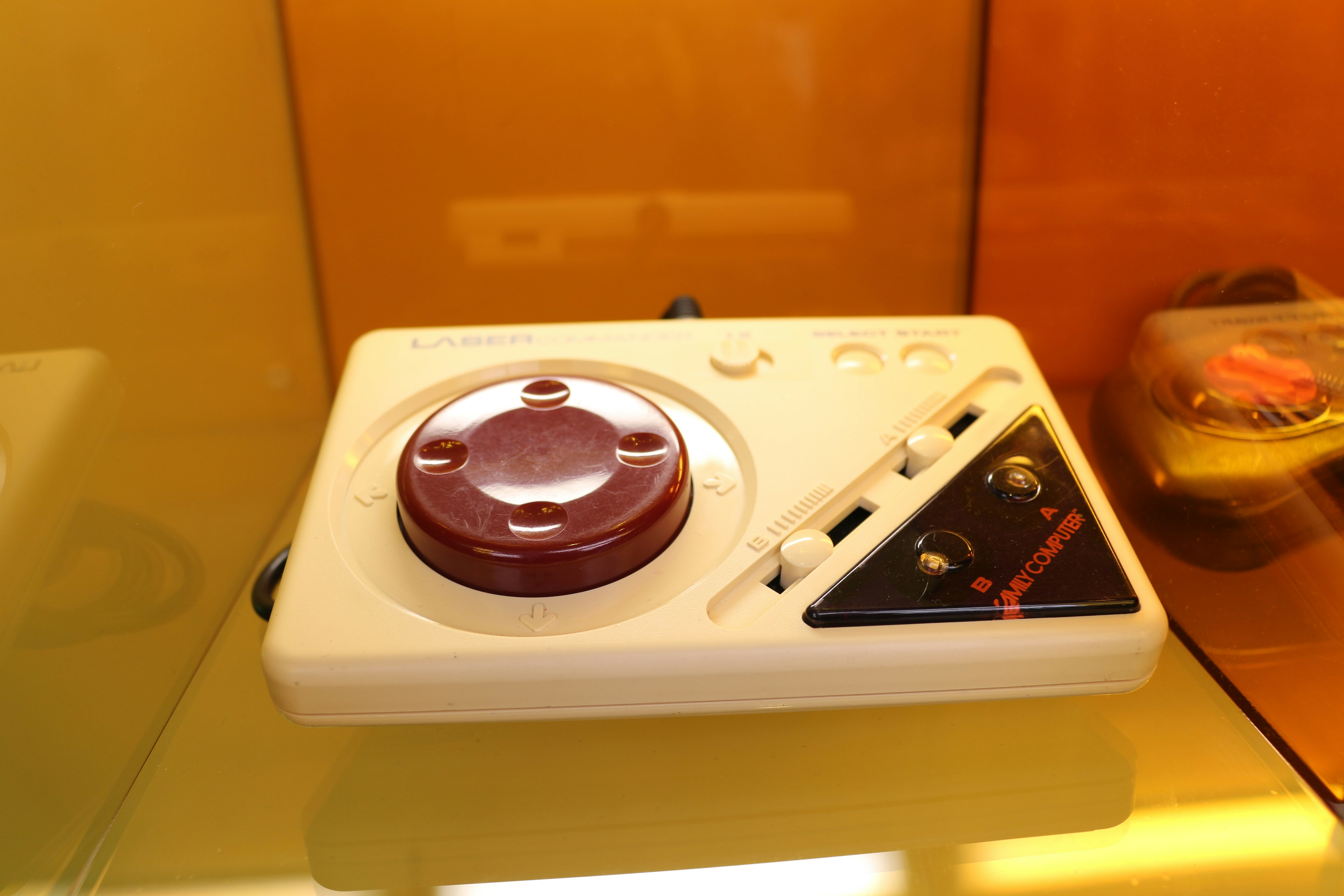 A white and red device sitting on top of a glass table