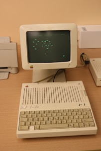 An old computer sitting on top of a wooden desk