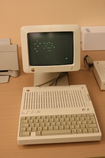 An old computer sitting on top of a wooden desk