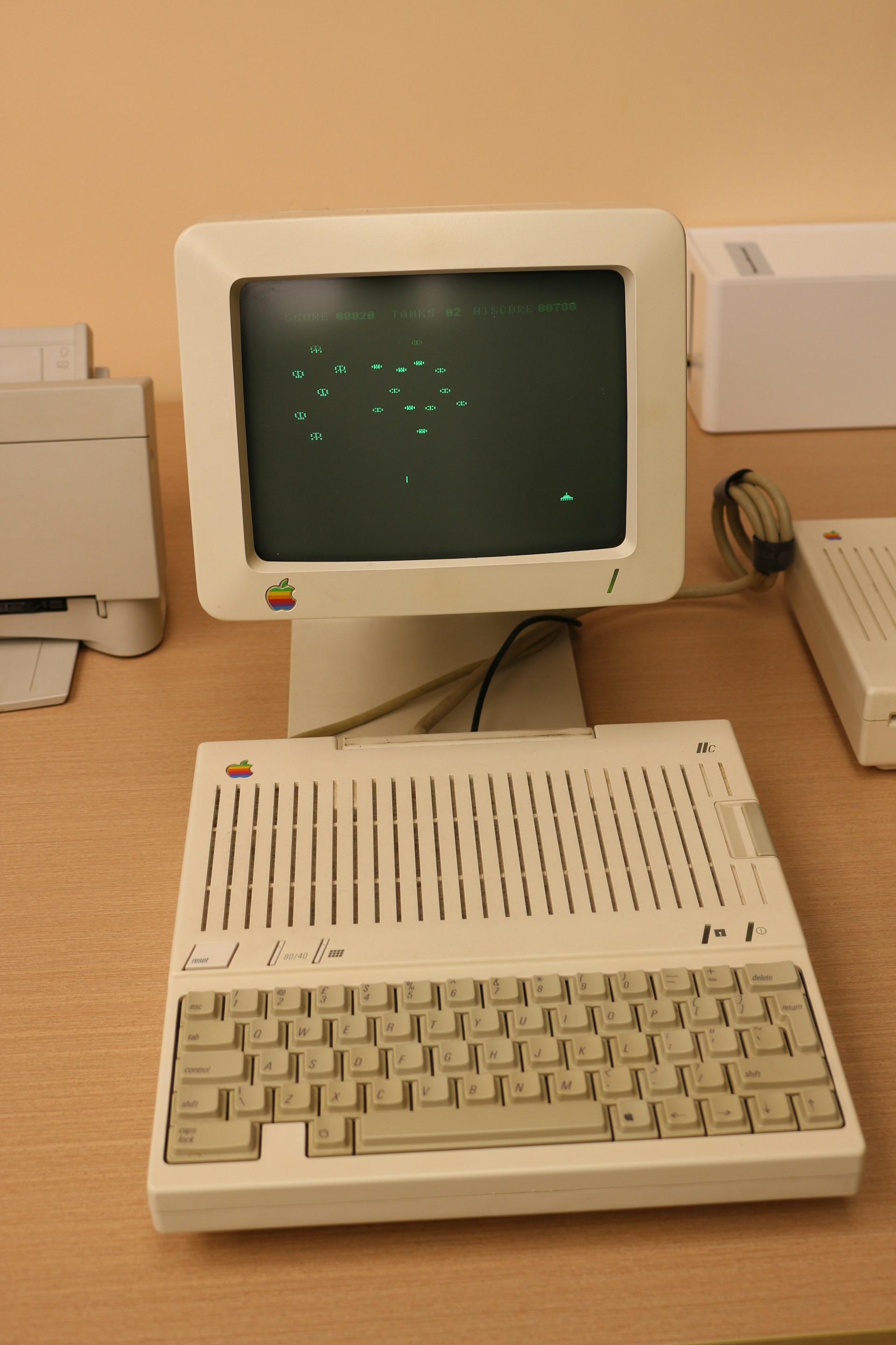 An old computer sitting on top of a wooden desk