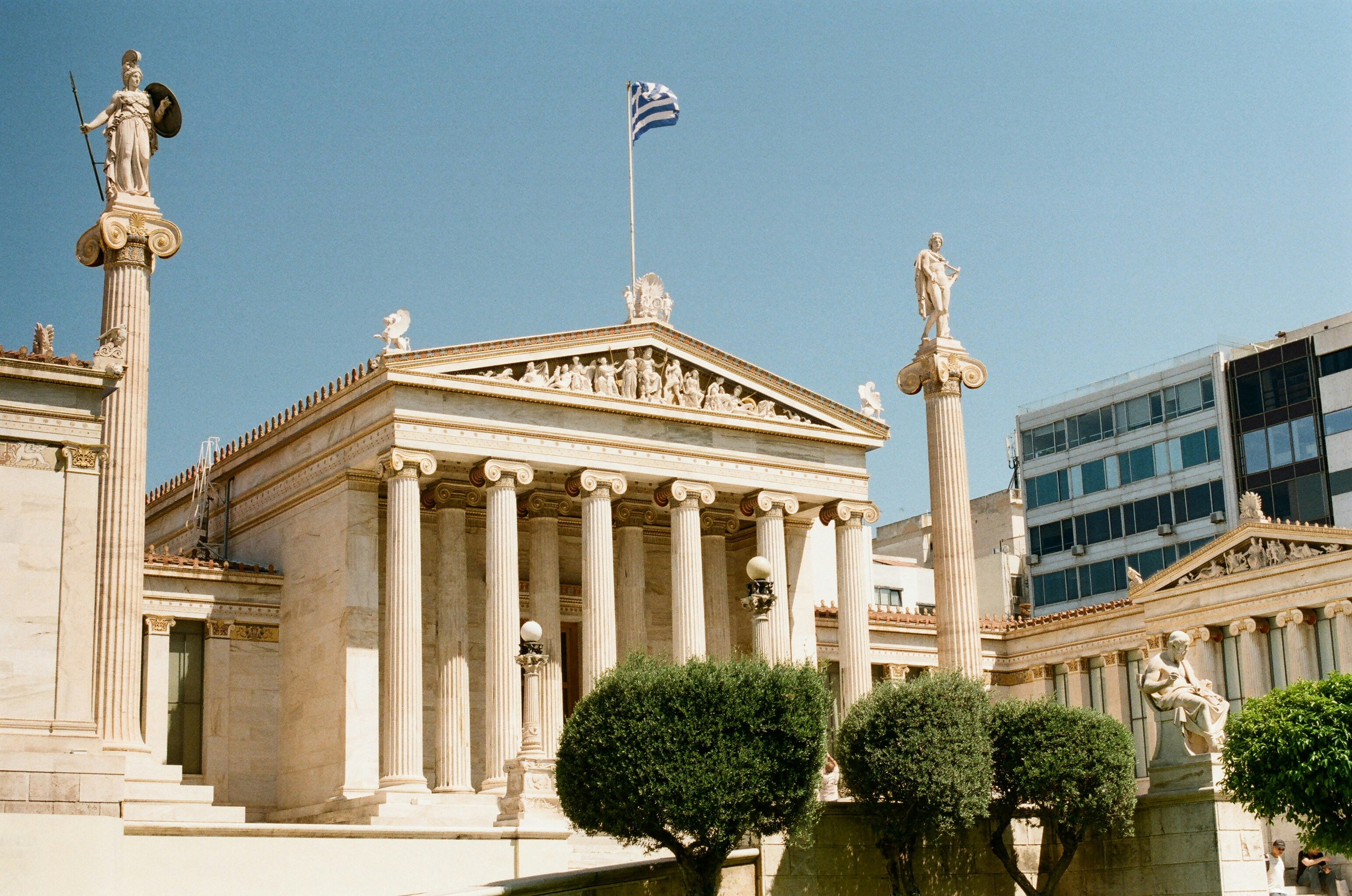 A building with columns and statues in front of it