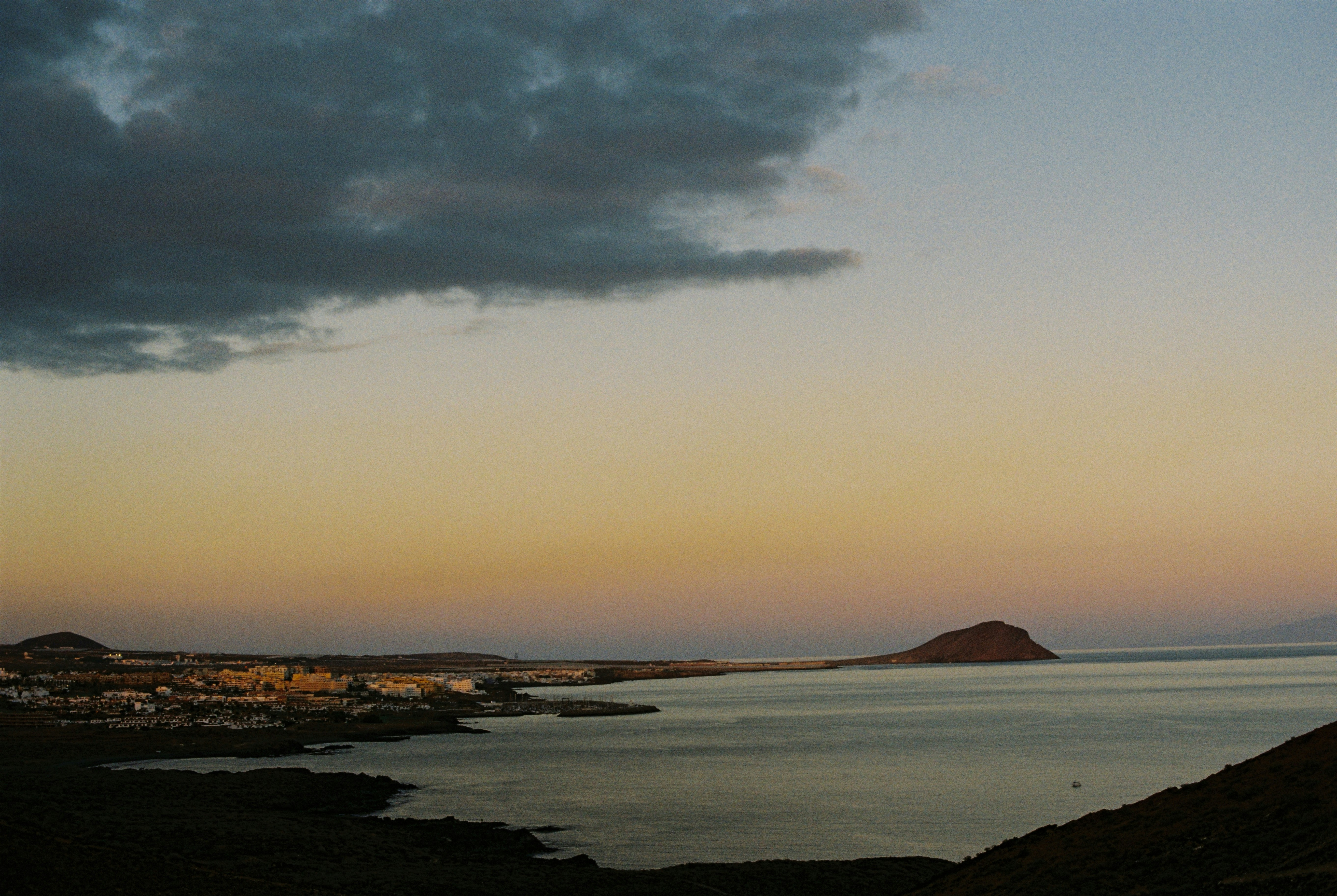 A large body of water sitting under a cloudy sky