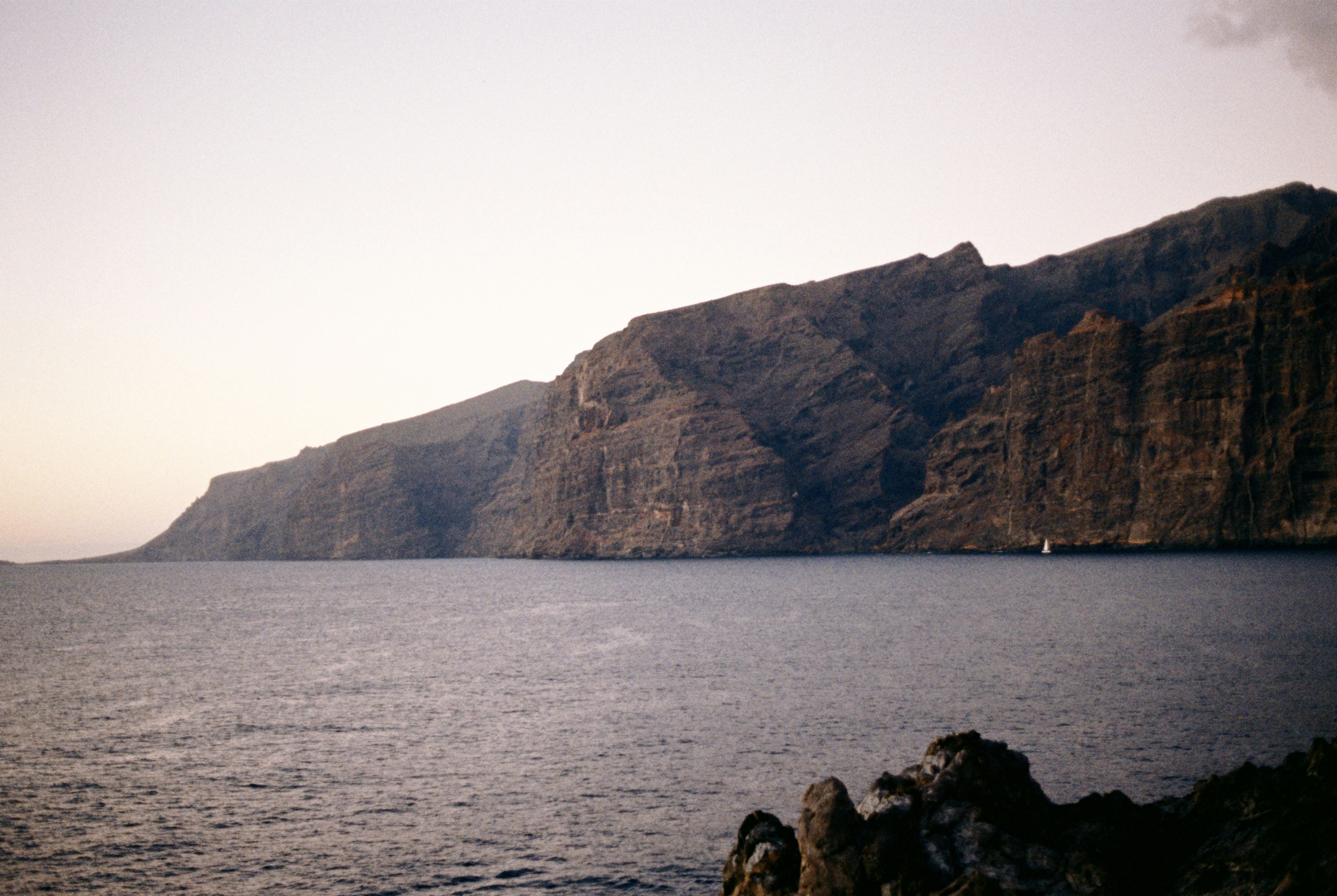 A large body of water with a mountain in the background