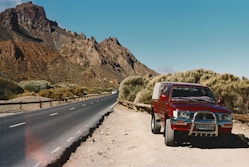 A red truck parked on the side of a road