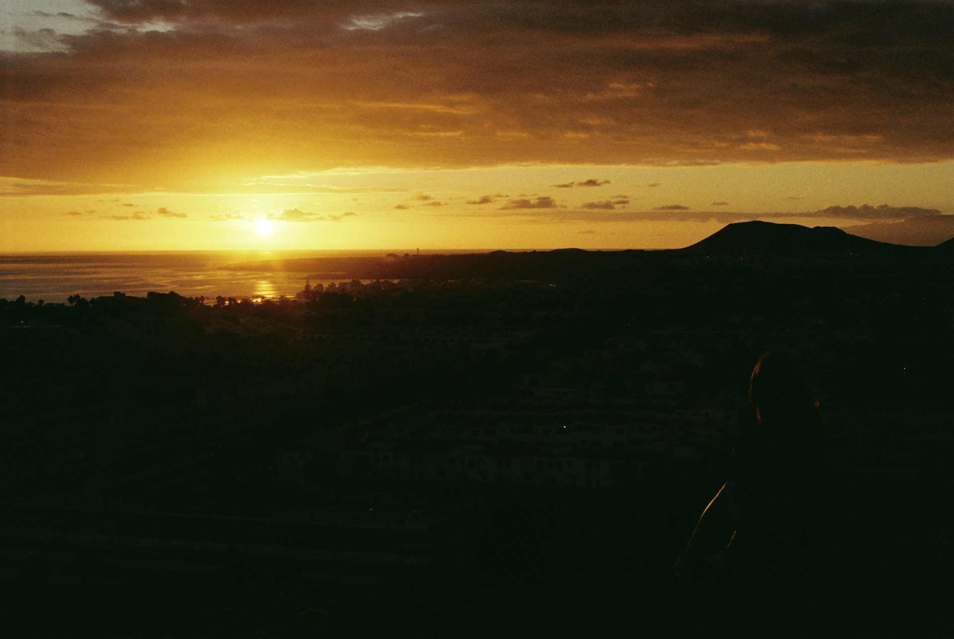 The sun is setting over a mountain range