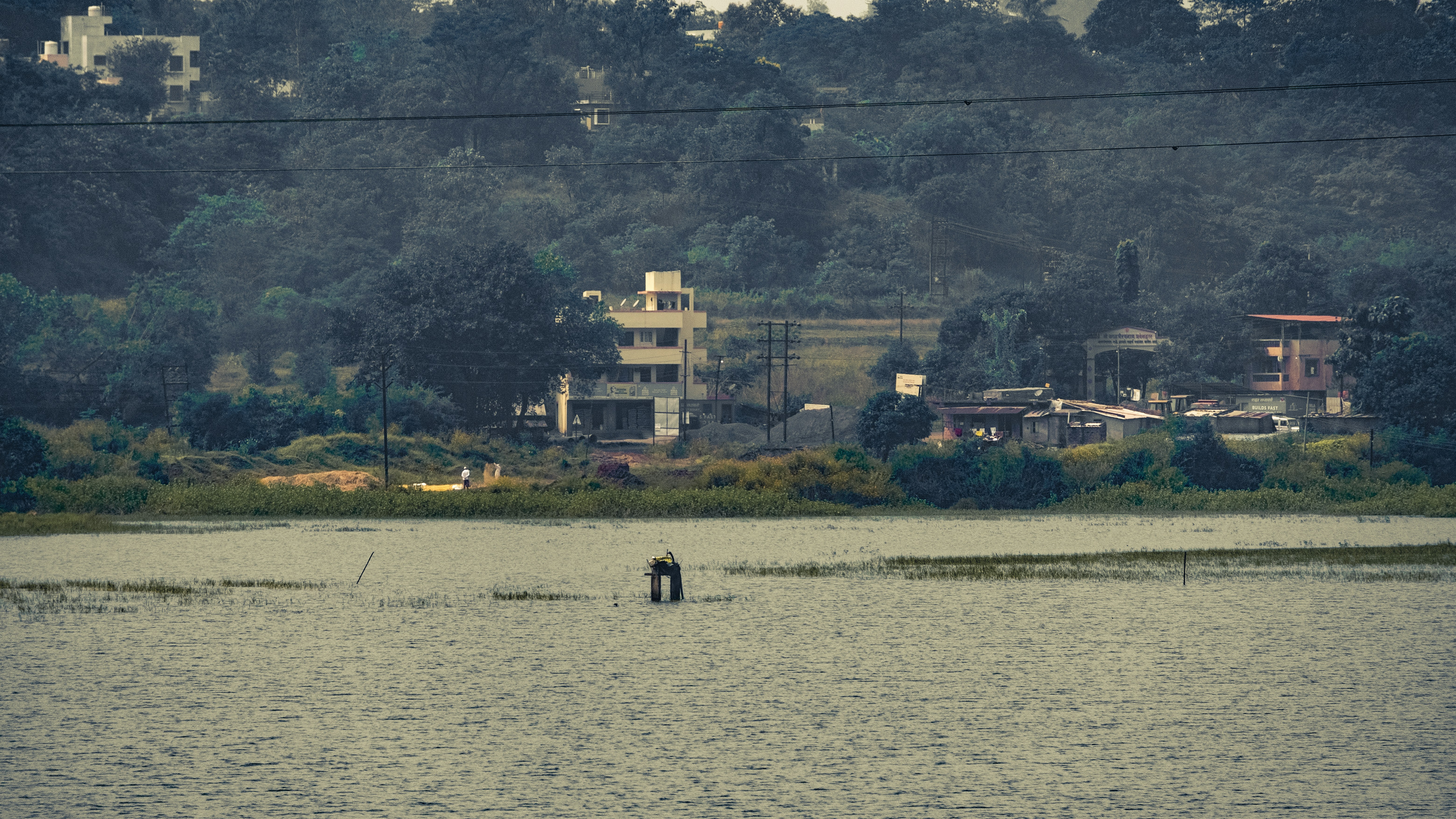 A body of water with a small boat in the middle of it