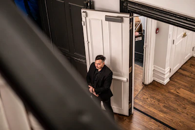 A man standing in front of a white door