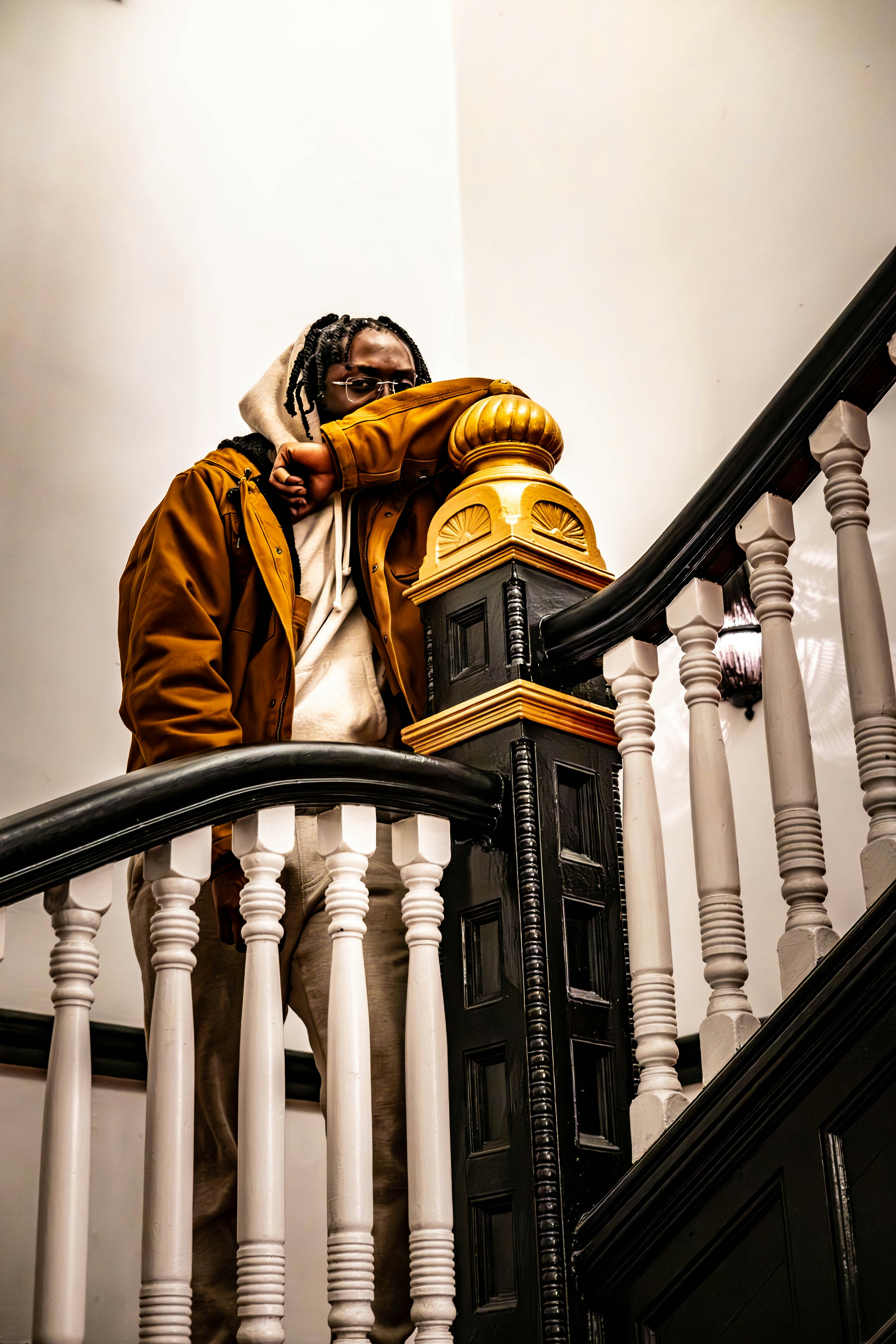 A man standing on a stair case next to a railing