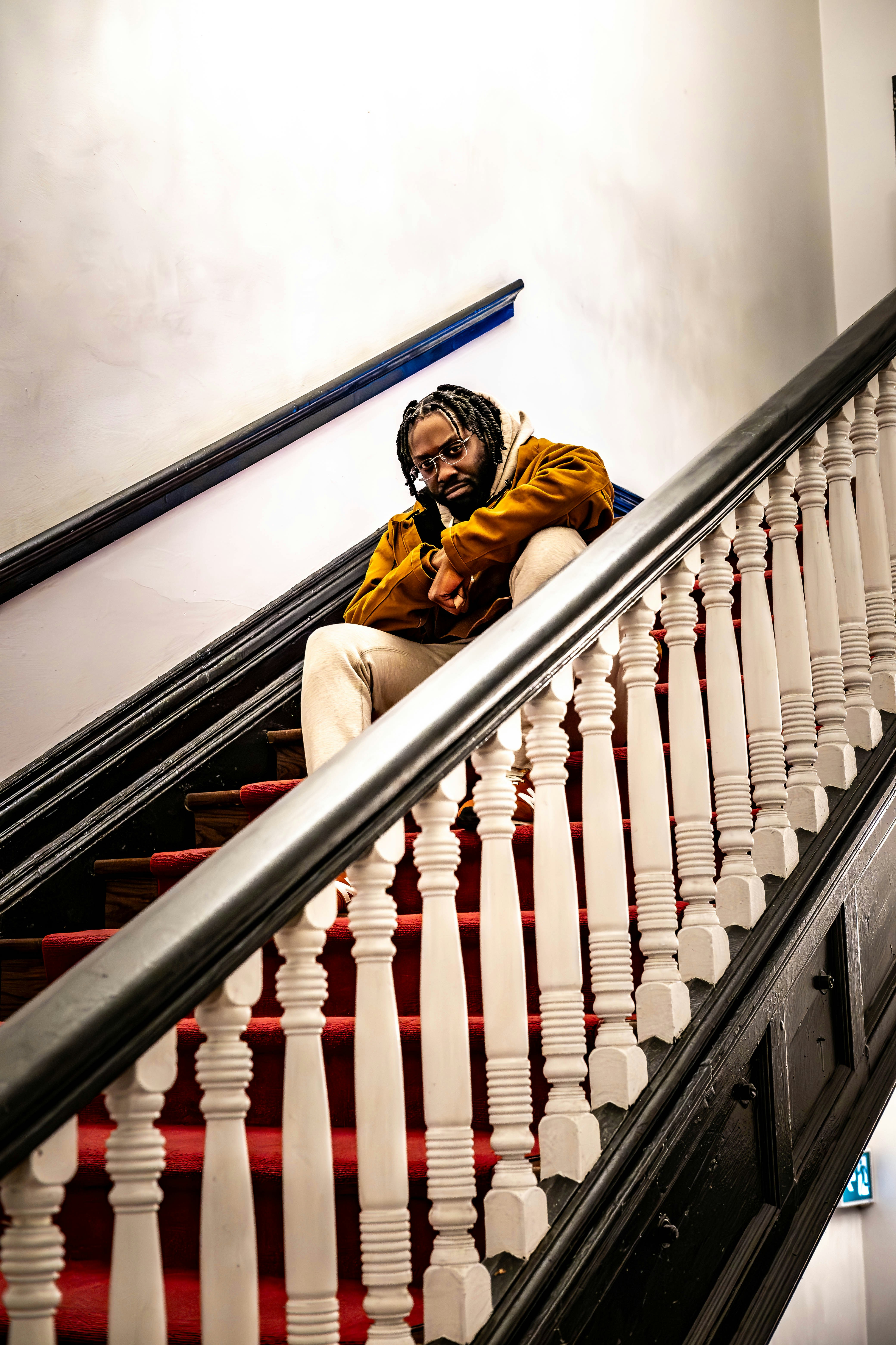 A man is sitting on a stair case