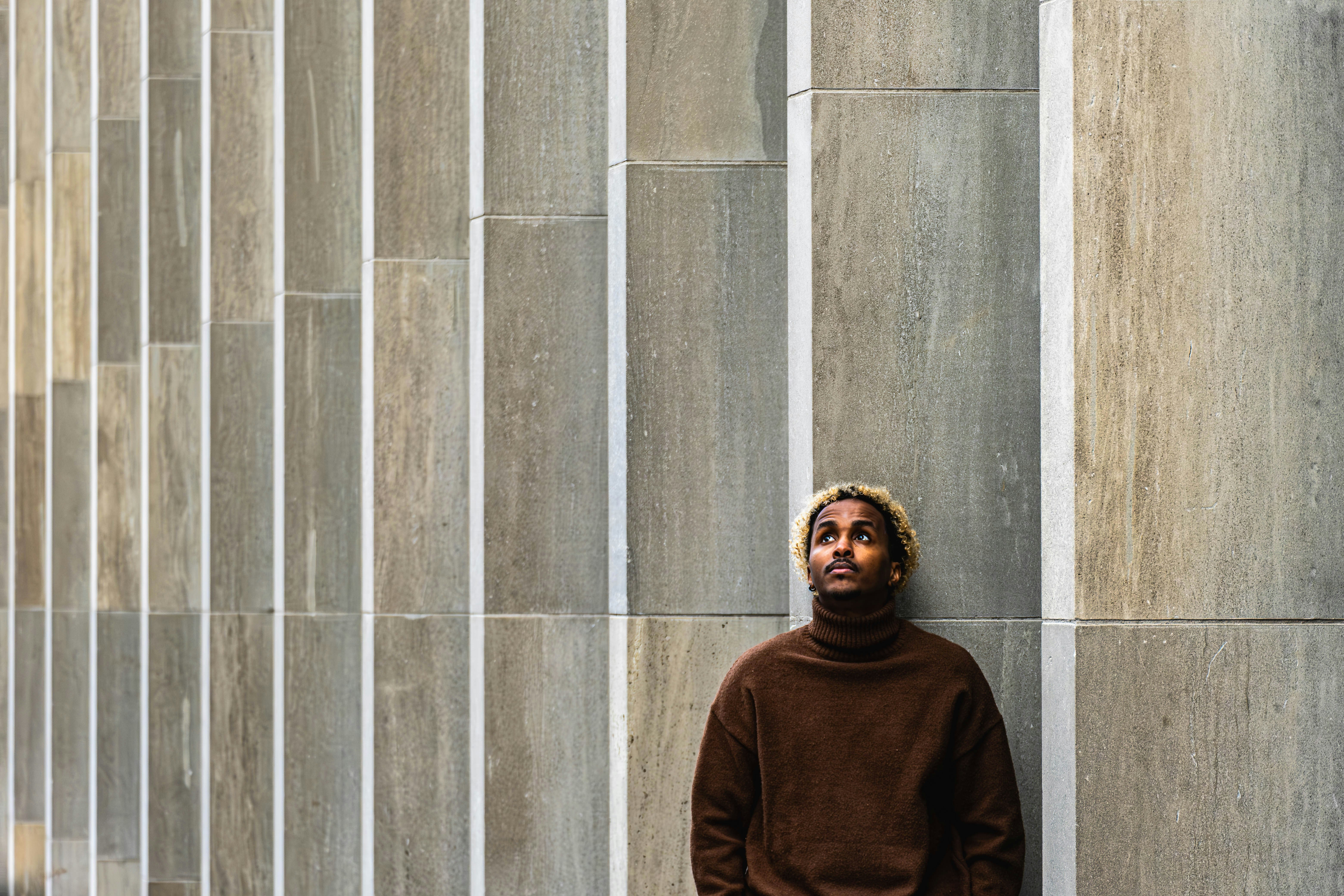 A man standing in front of a tall building