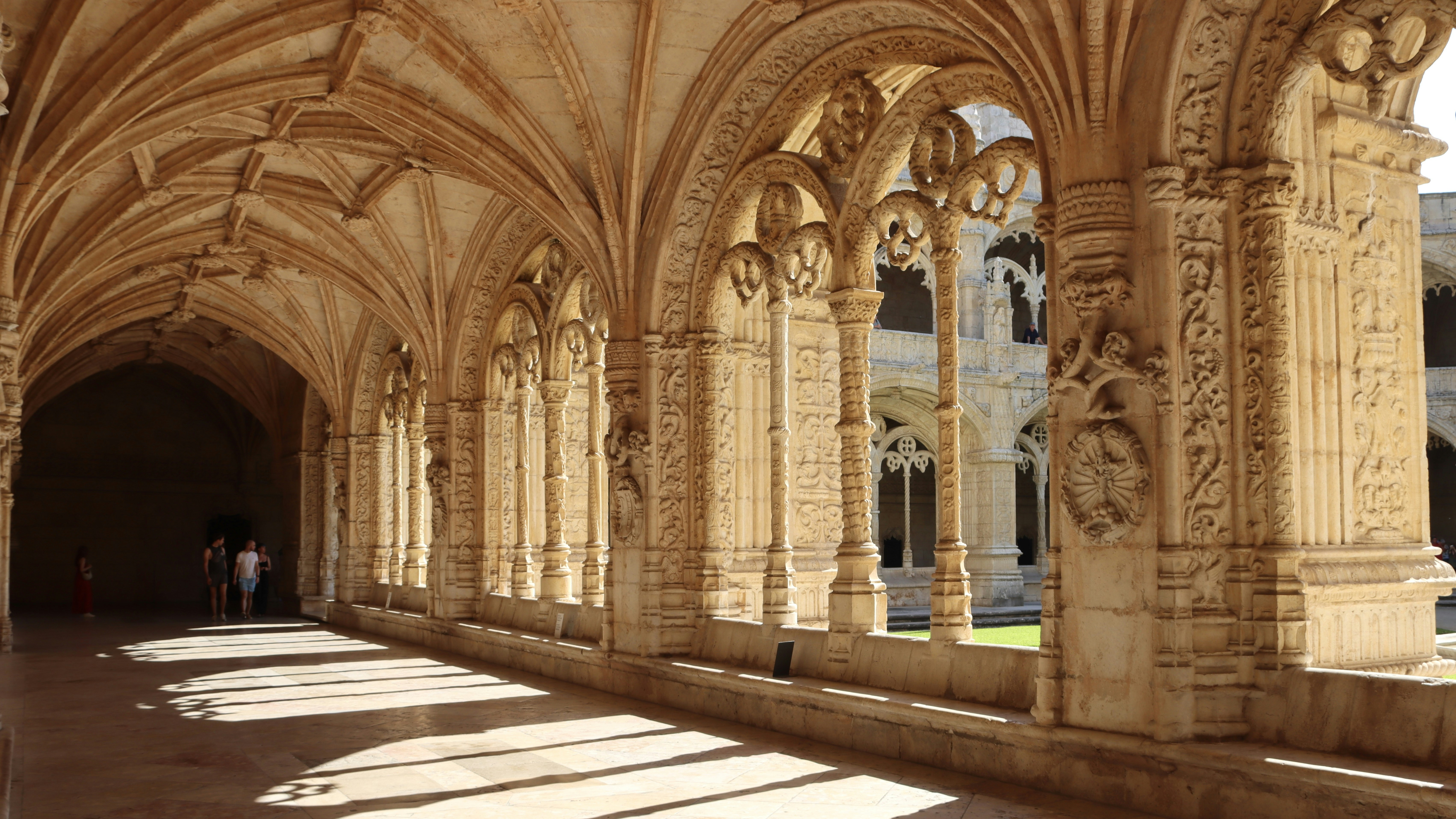 A long hallway with arches and columns in a building