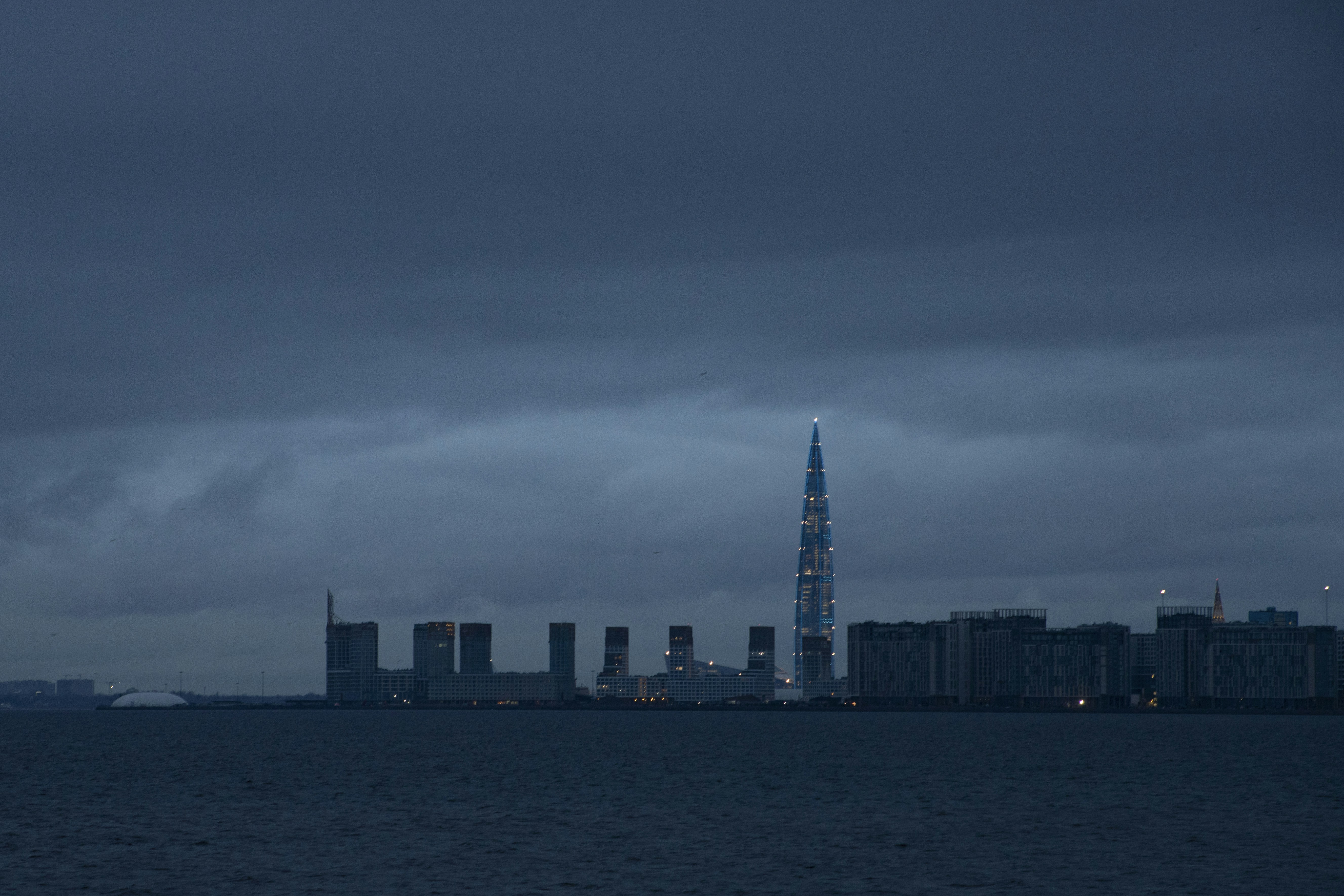 A large body of water with a city in the background