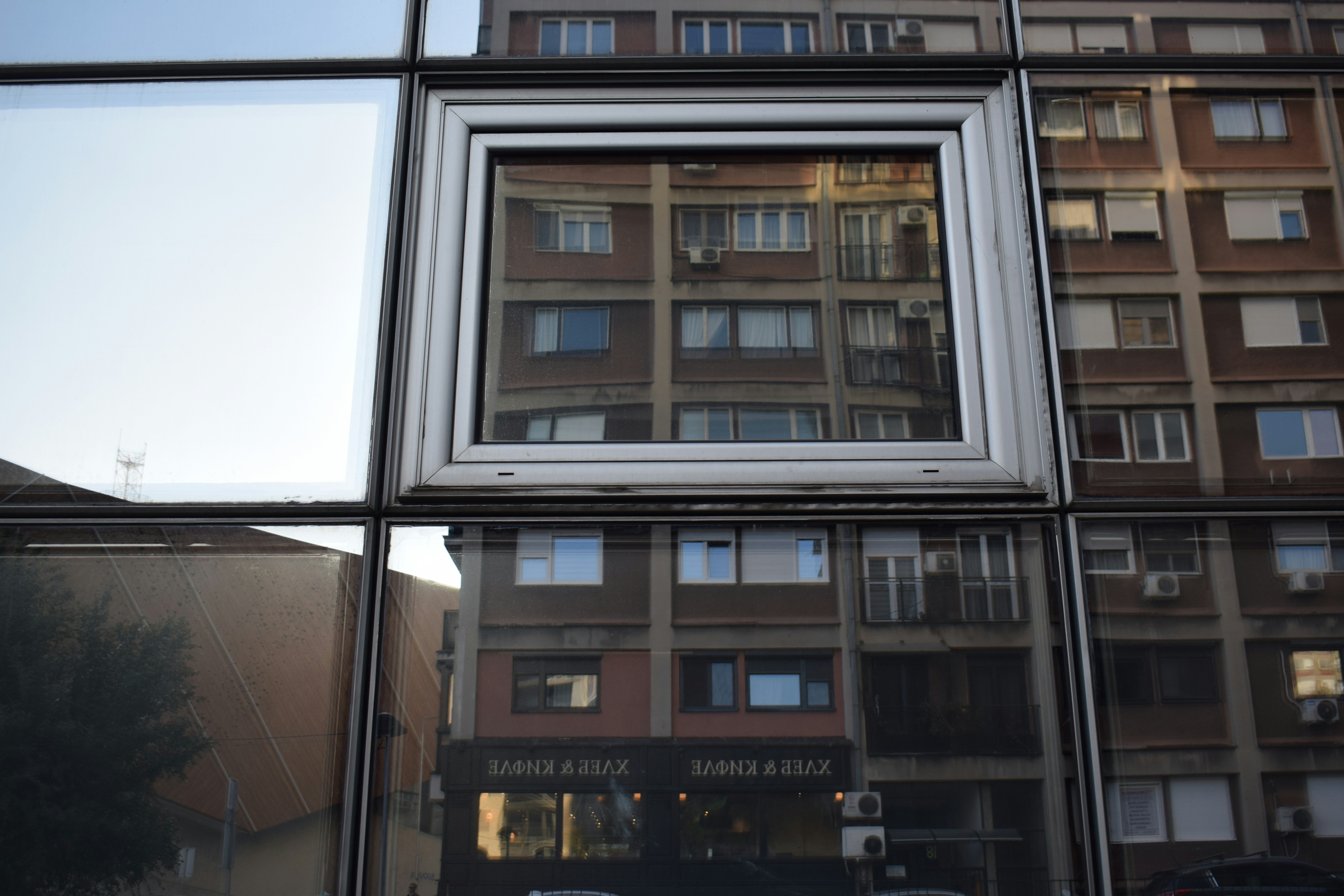 A reflection of a building in a window