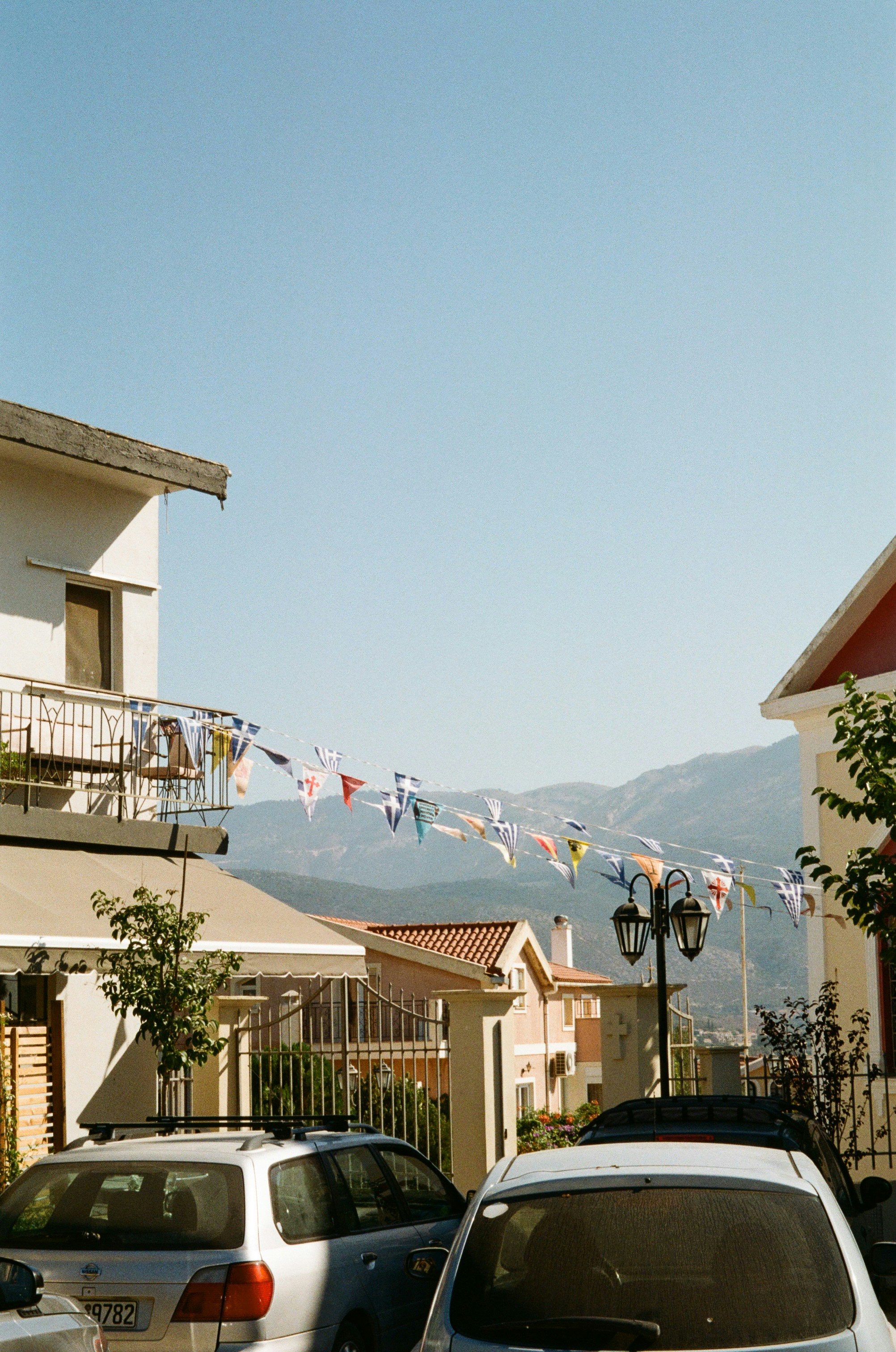 Cars parked in front of a row of houses