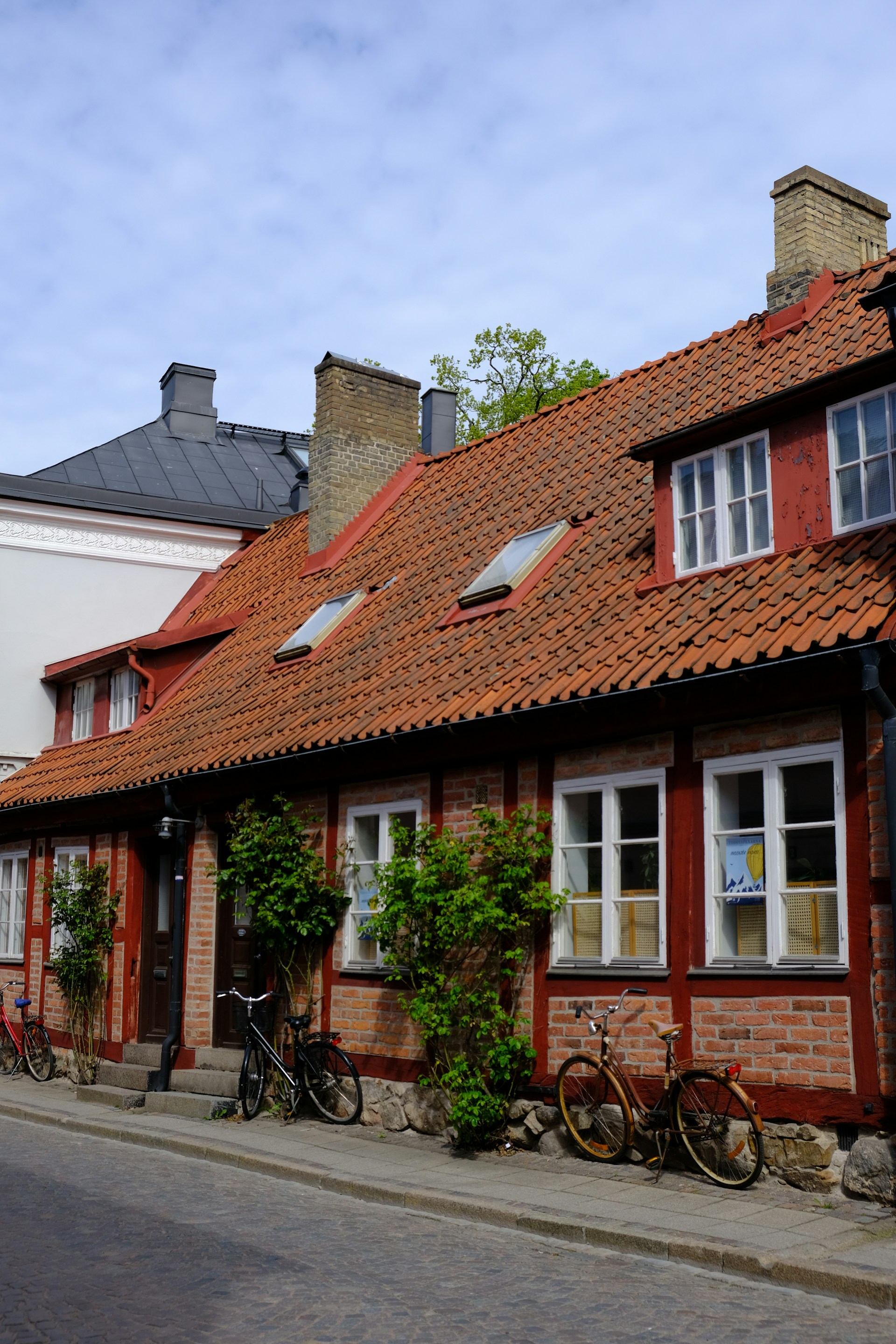 A row of houses with bicycles parked on the side of the street
