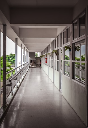 A long school hallway lined with windows, representing Southern Nevada public school campuses affected by education governance decisions