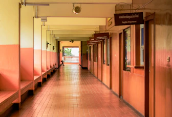 A long hallway with benches and a sign on the wall