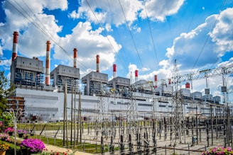 A power plant with lots of power lines in front of it