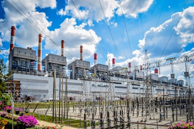 A power plant with lots of power lines in front of it