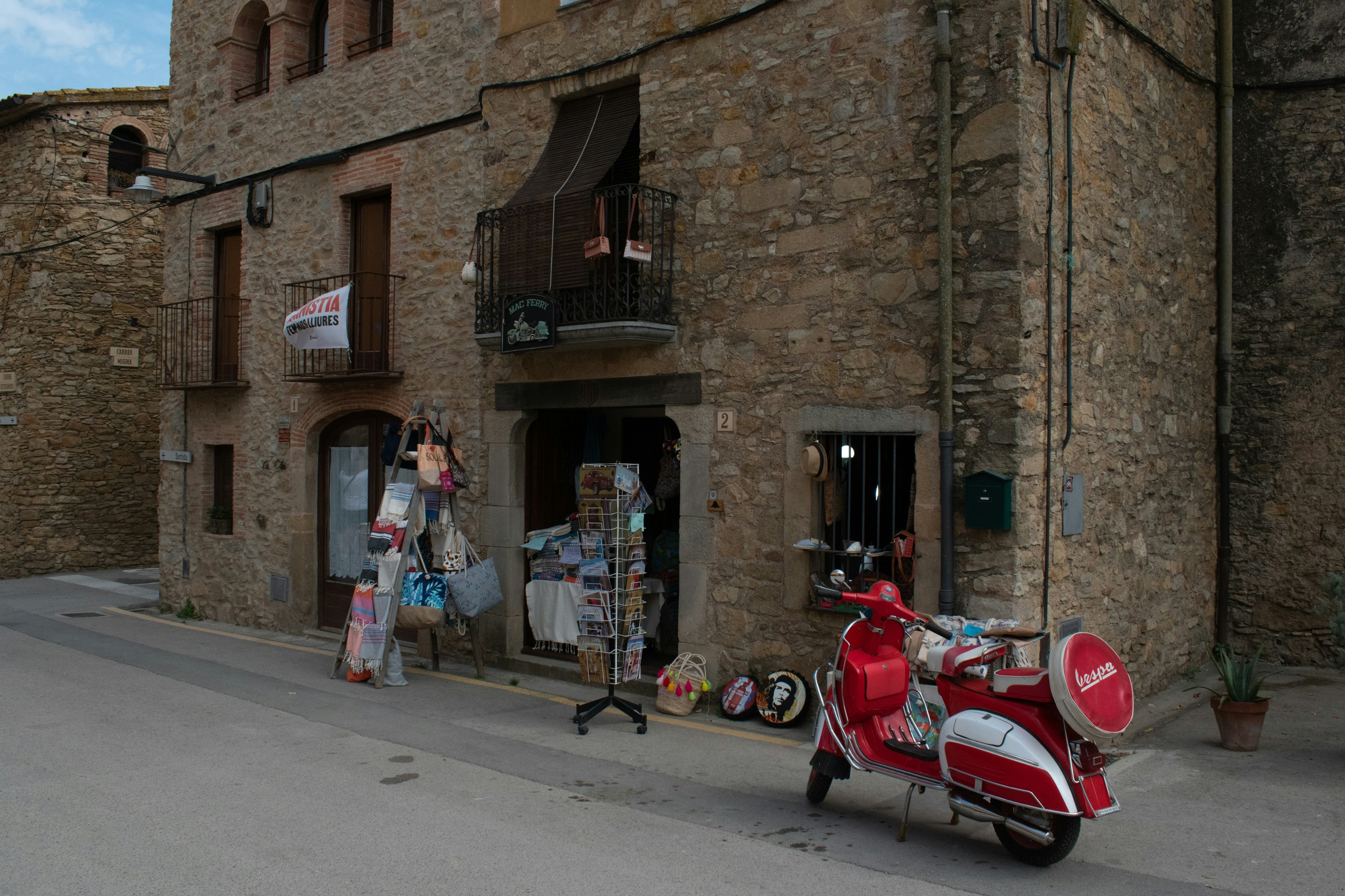A red scooter parked in front of a building