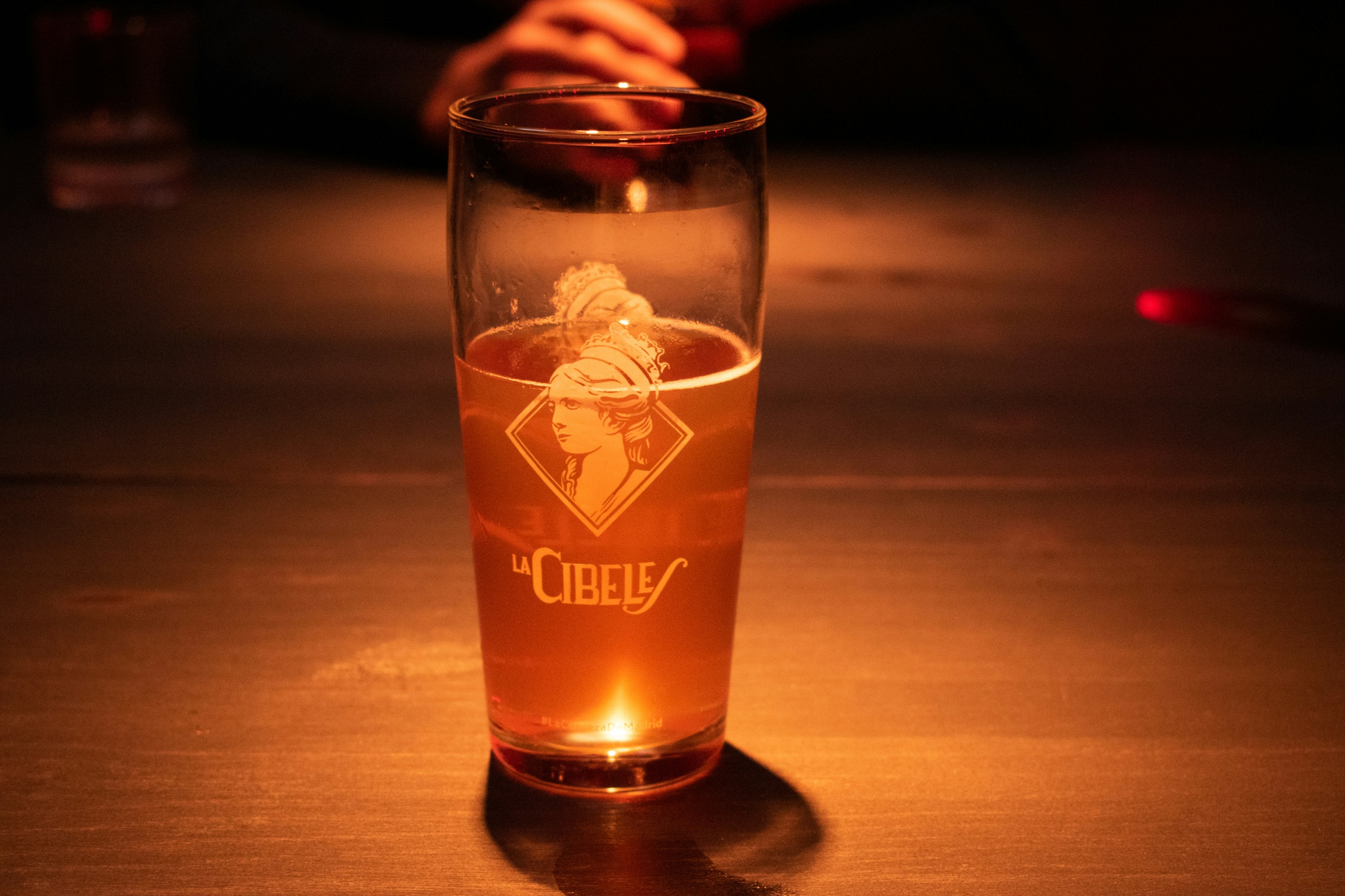 A glass of alcohol sitting on a table