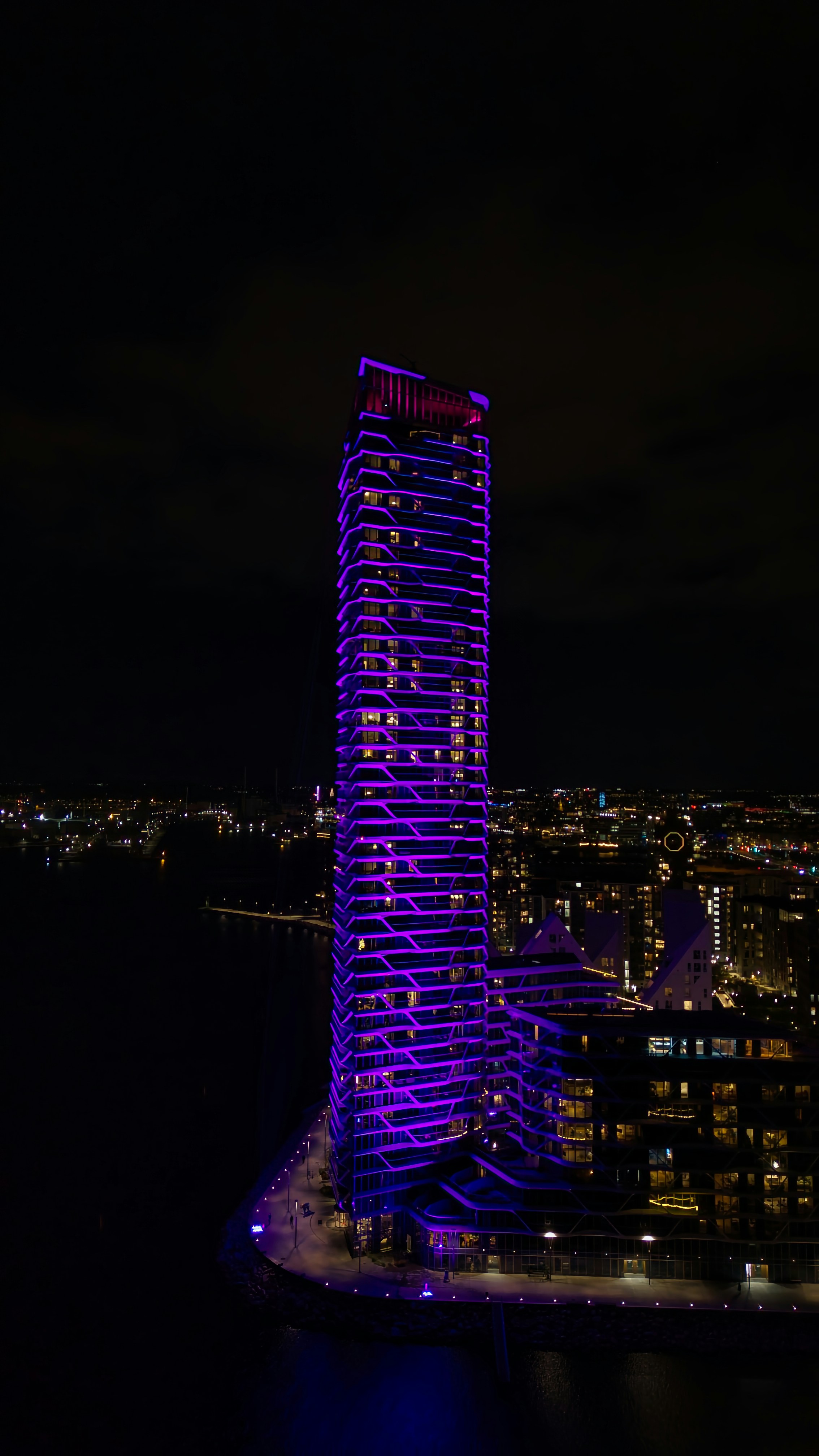 A very tall building lit up at night