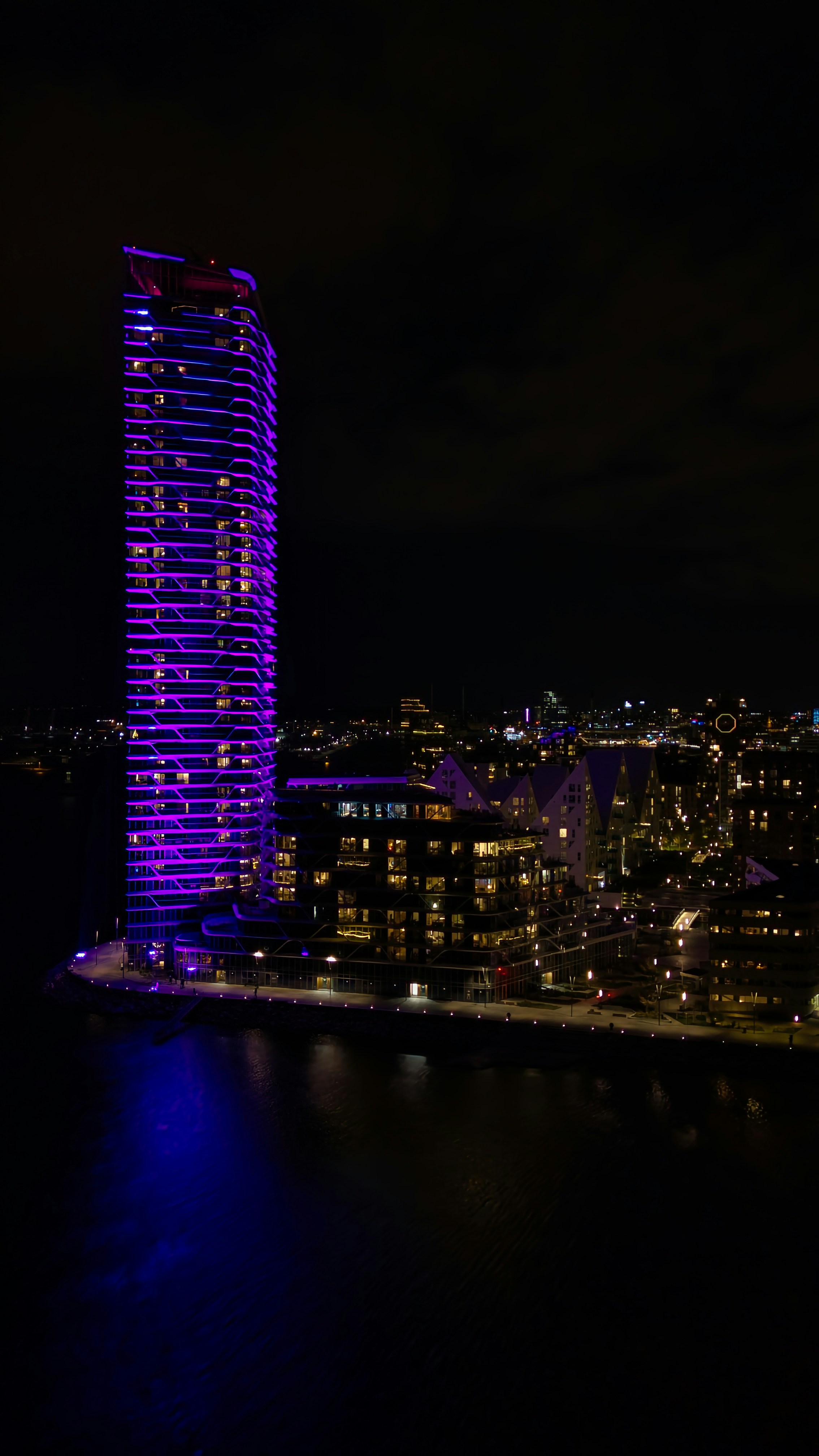 A very tall building lit up at night