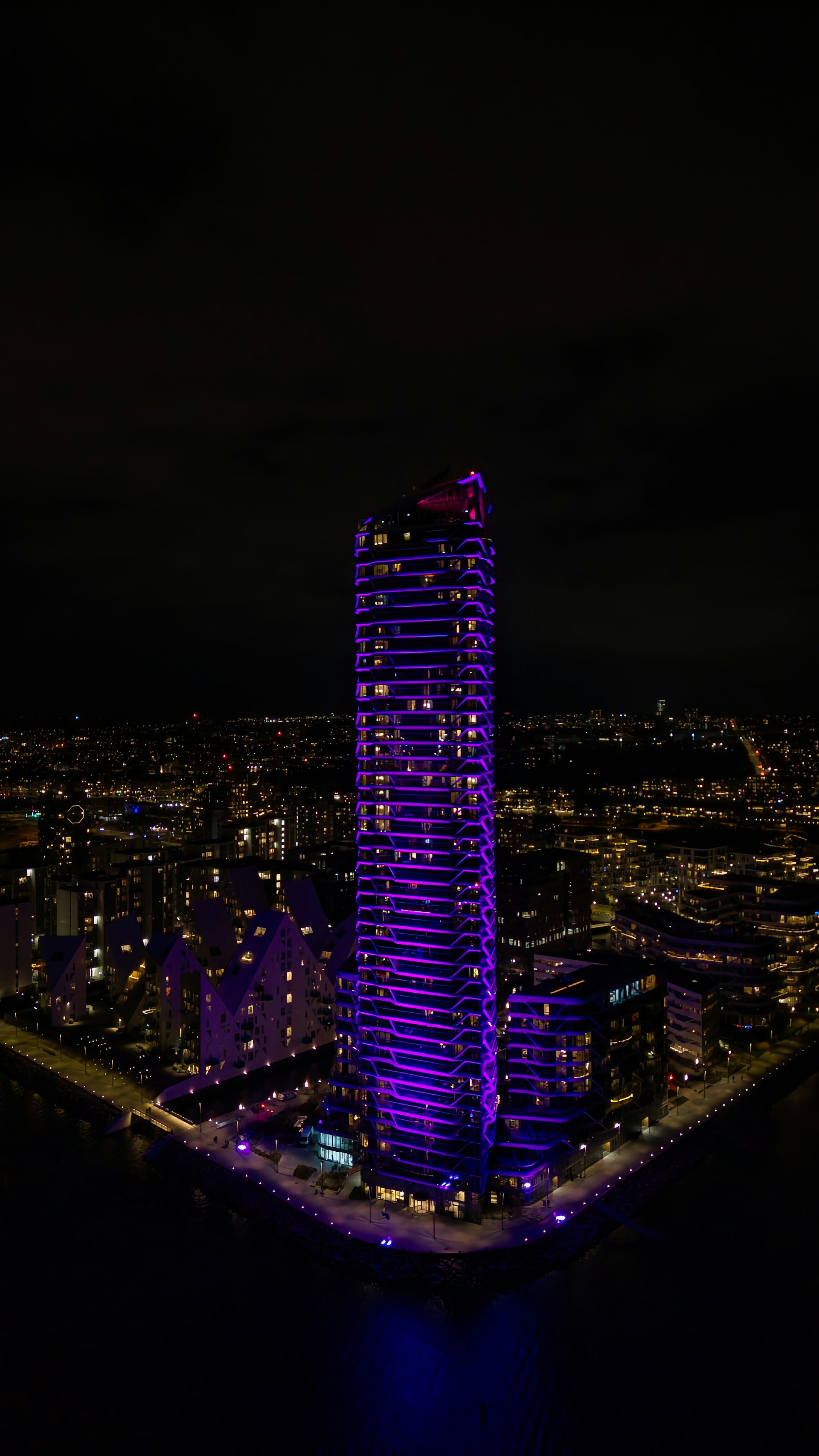 A very tall building lit up at night