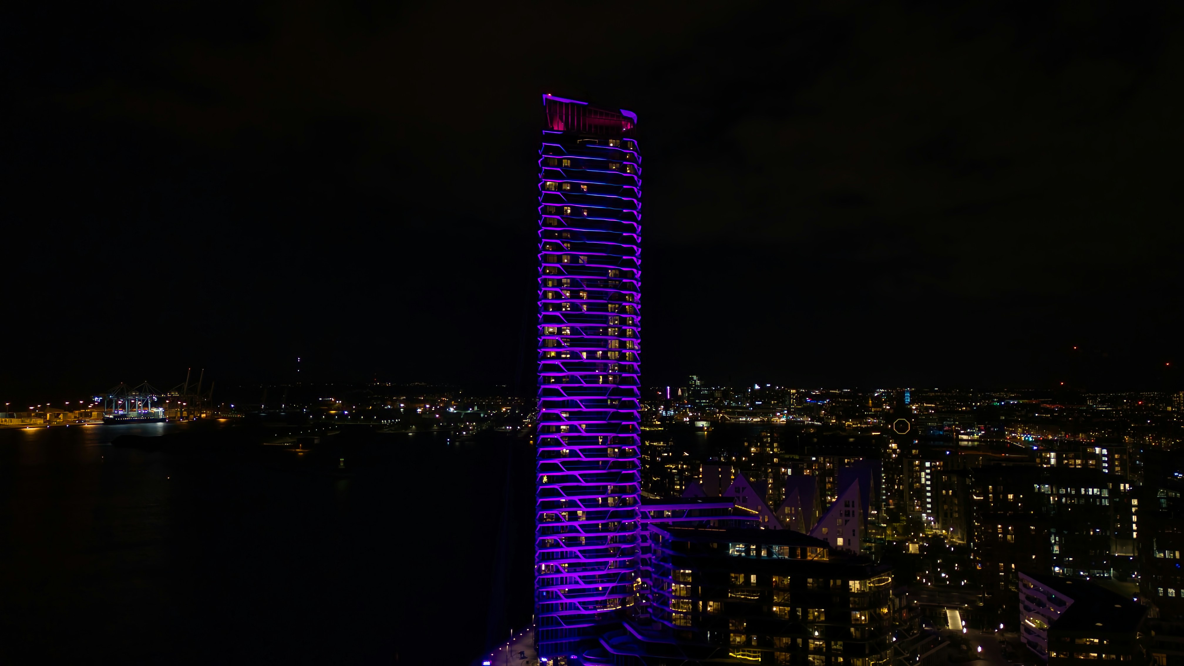 A very tall building lit up at night