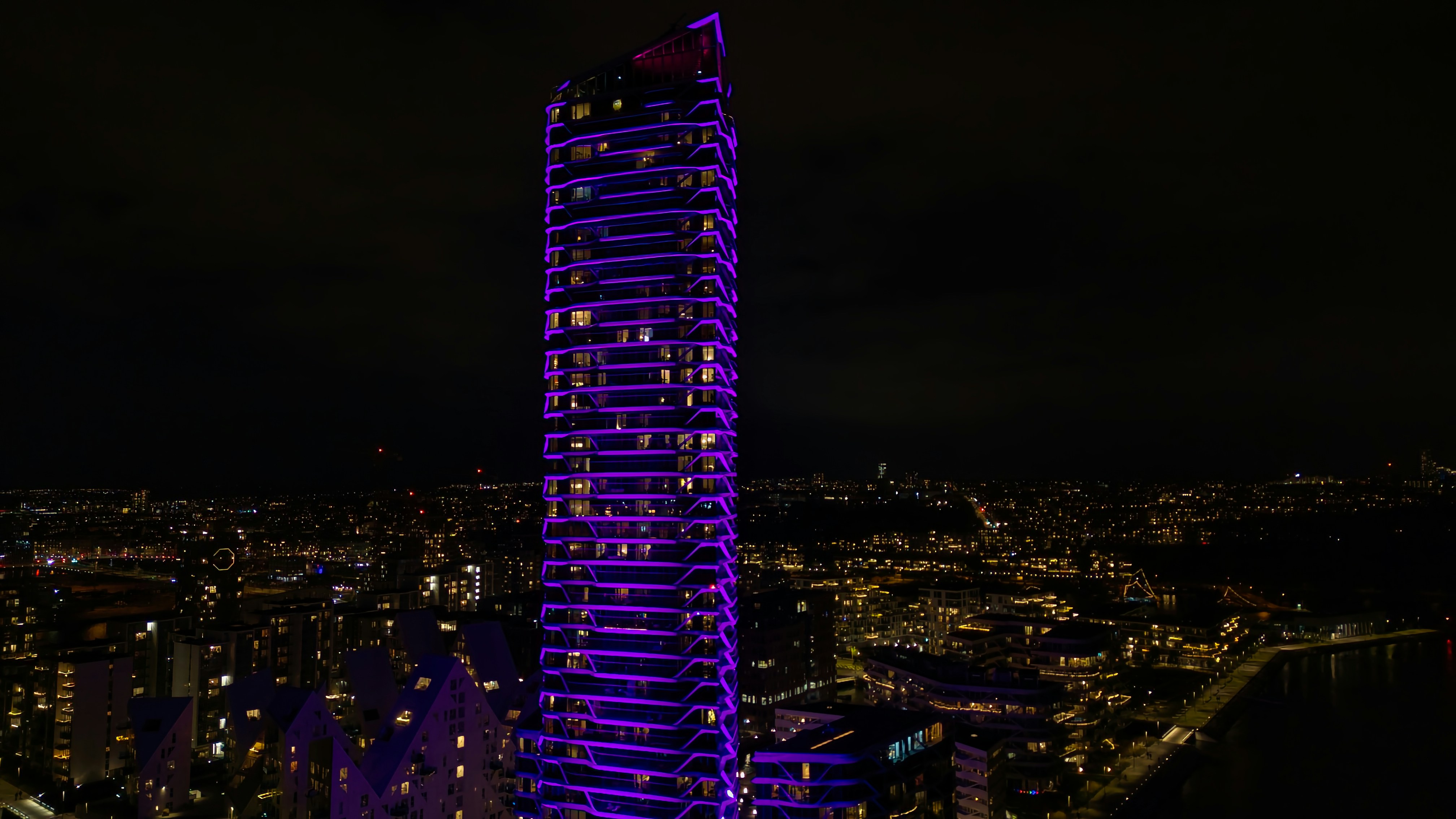 A very tall building lit up at night