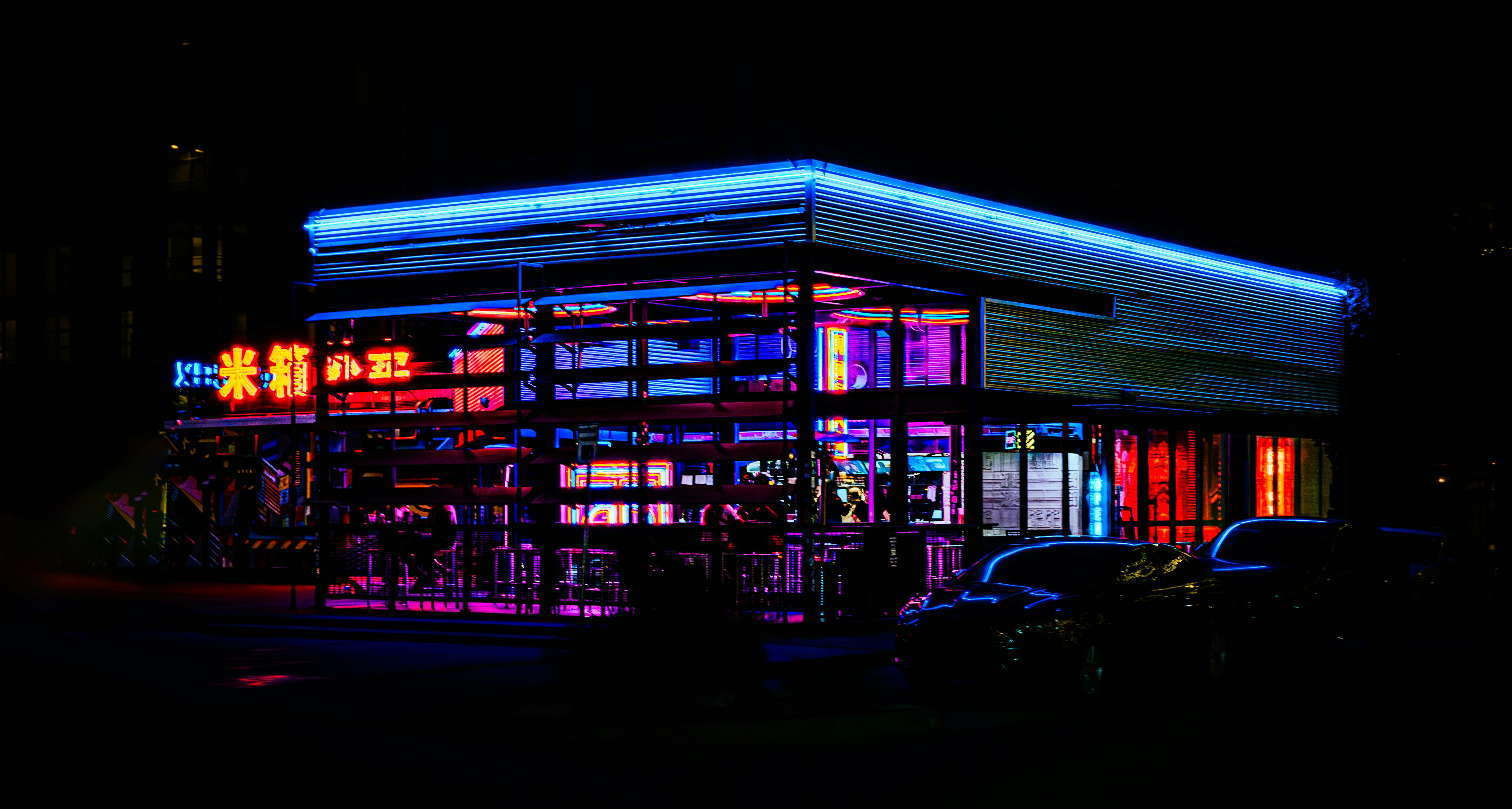 A lit up building in the dark at night, 
