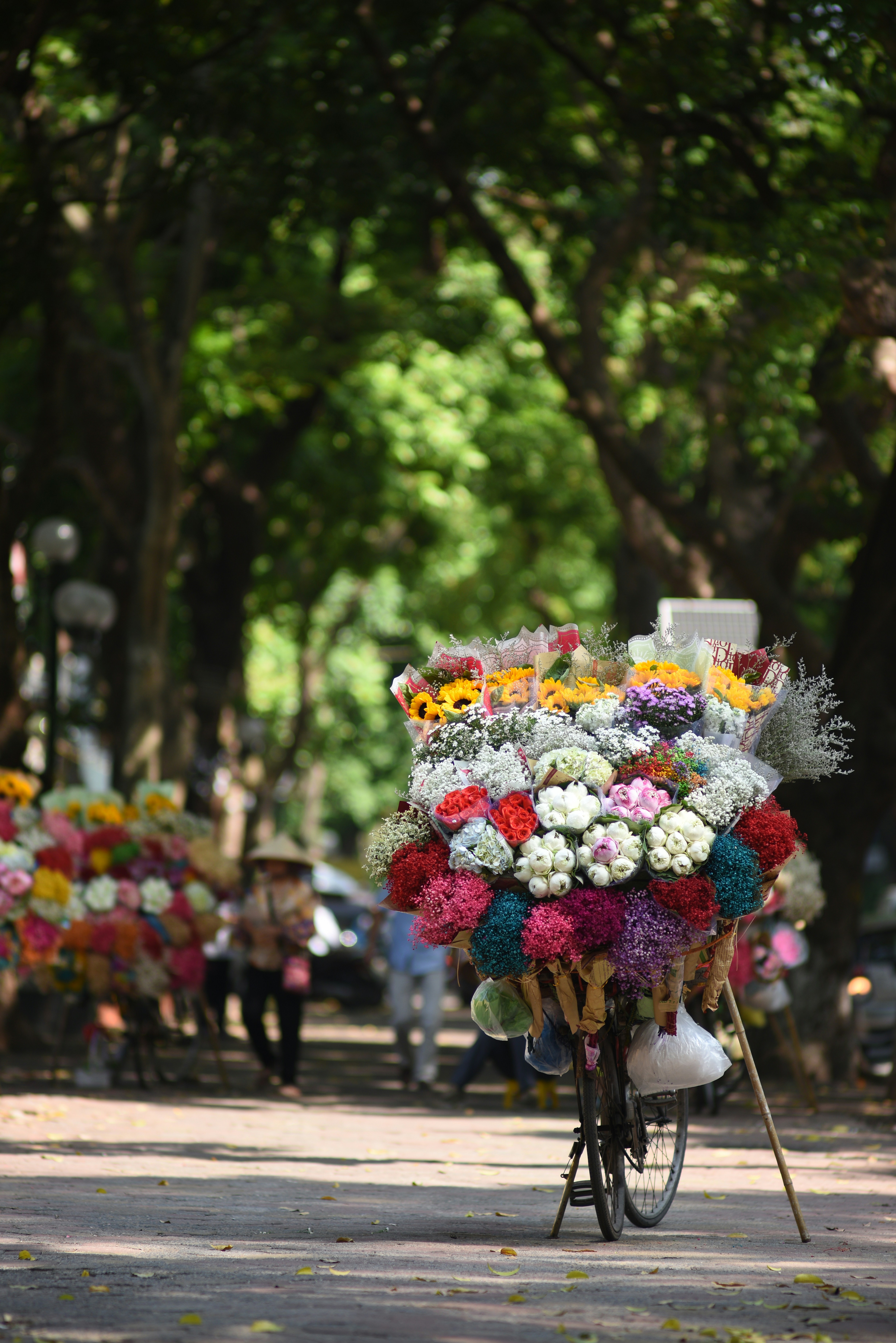 A bicycle with a bunch of flowers on the back of it