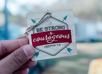 A person holding a small card with a message on it